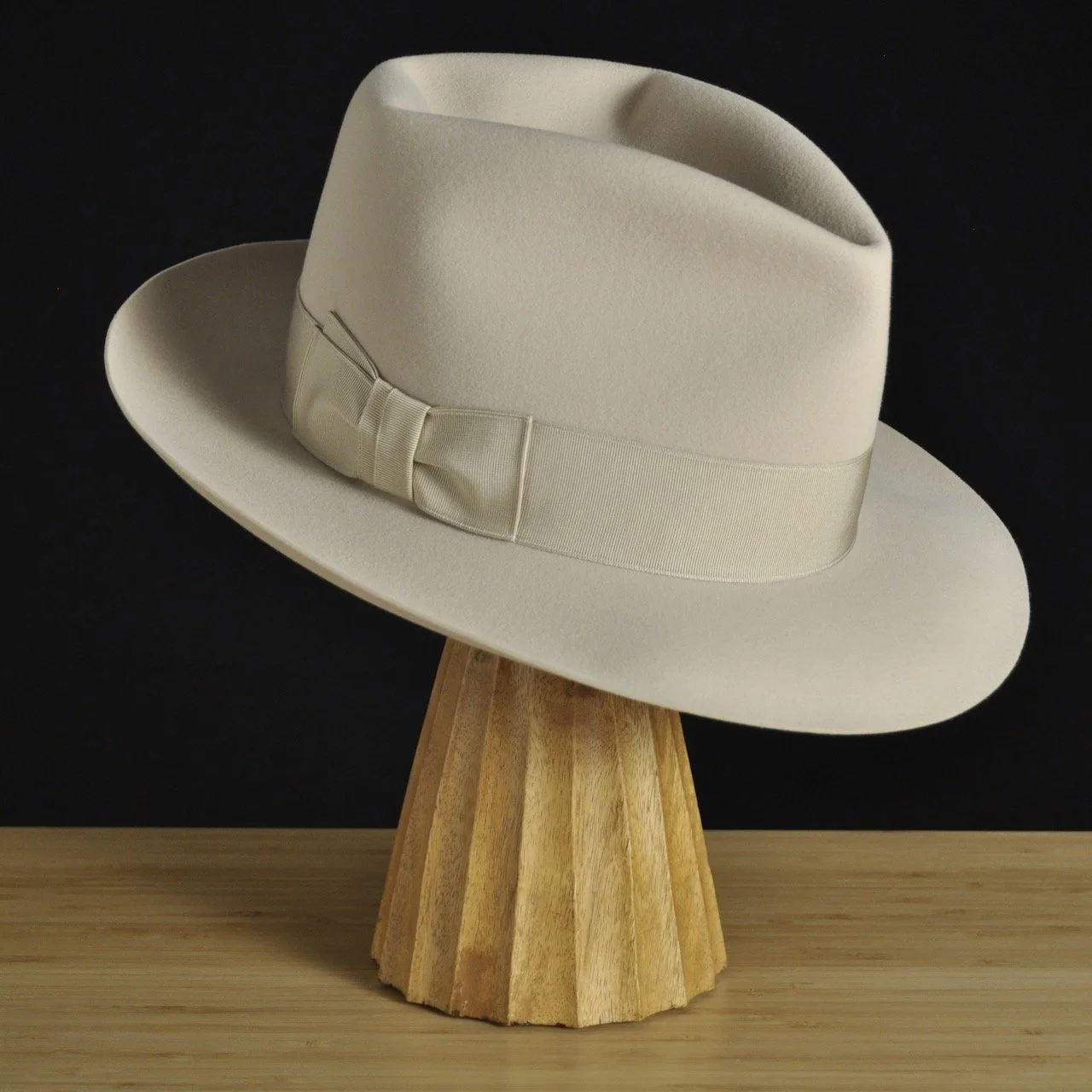 Three-quarter front left view of The Vintner ivory felt fedora with a softly pinched crown, medium snap brim, and matching ivory grosgrain ribbon with classic double bow.