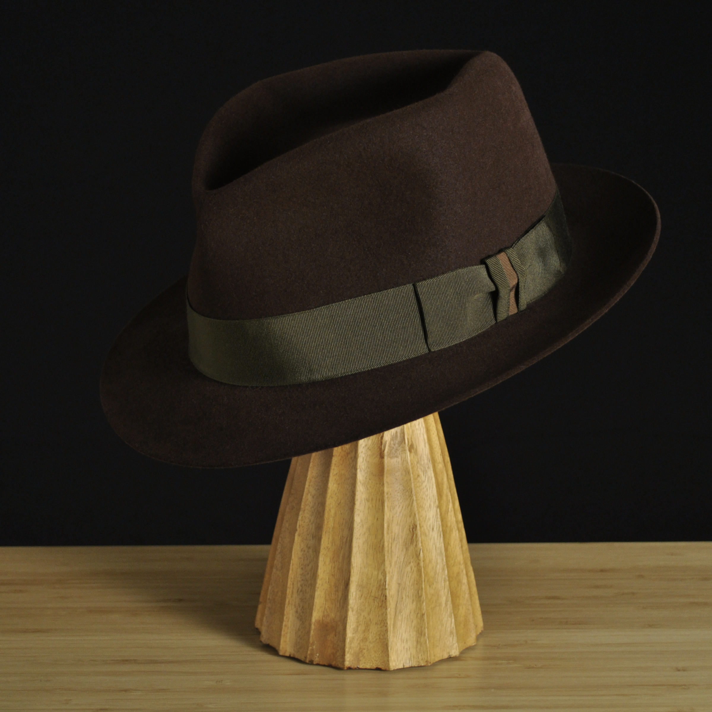 Three-quarter front left view of The Hielander brown felt fedora with a softly pinched crown, medium snap brim, and olive grosgrain ribbon with classic bow.