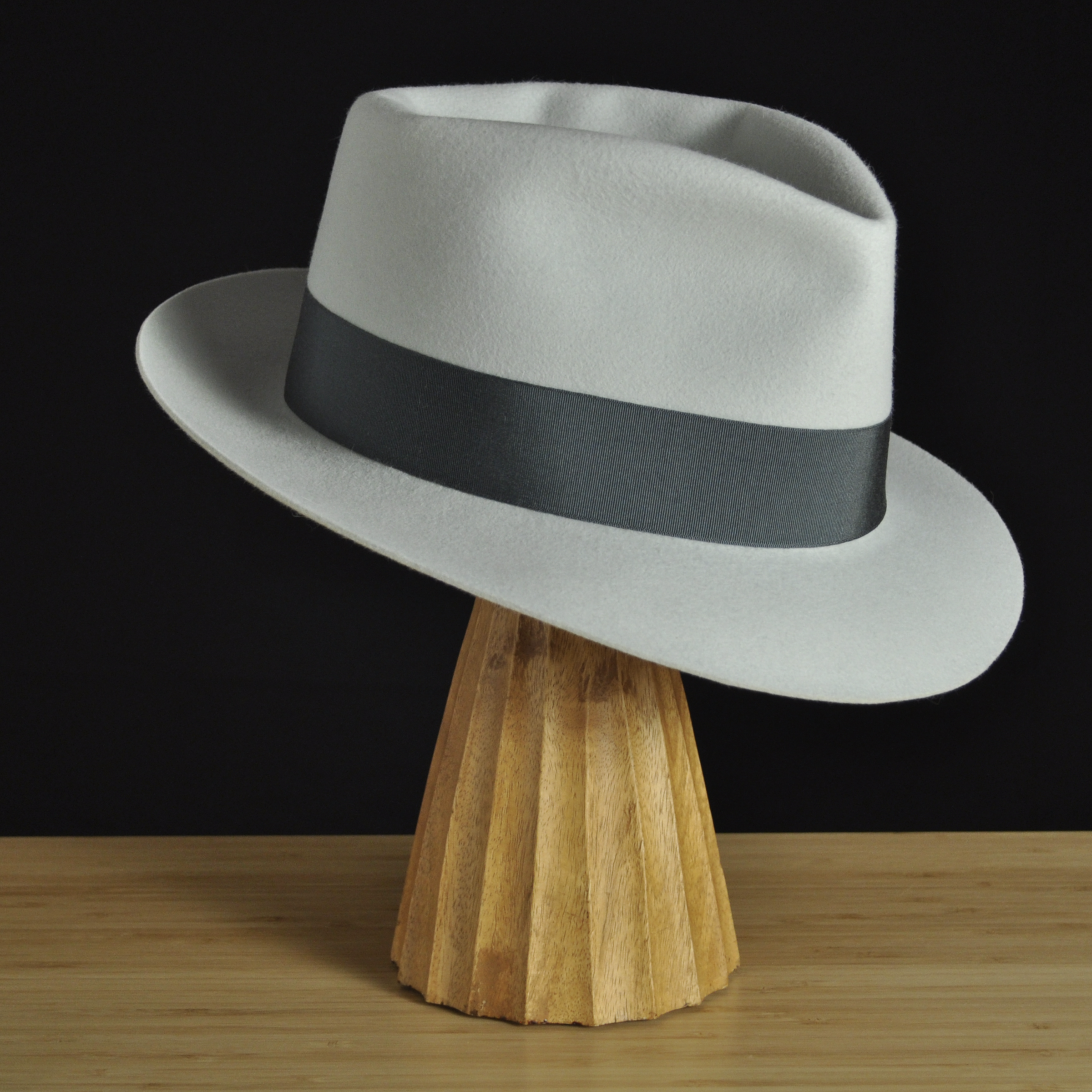 Three-quarter front right view of The Sunsetter silvermist felt fedora with a softly pinched crown, medium snap brim, and contrasting dark grosgrain ribbon with a modern tie (no bow).