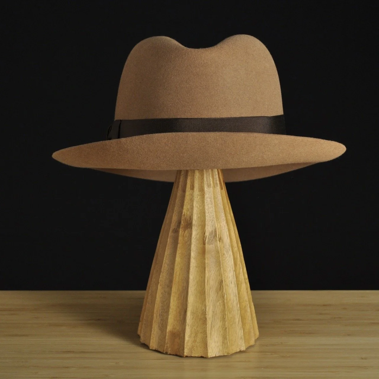Rear view of The Vendômer tan felt fedora with a softly pinched crown, medium snap brim, and dark brown grosgrain ribbon with classic bow.