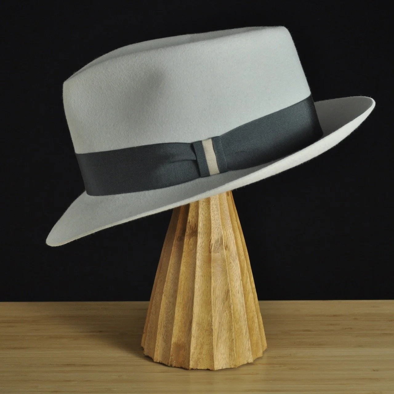 Left view of The Sunsetter silvermist felt fedora with a softly pinched crown, medium snap brim, and contrasting dark grosgrain ribbon with a modern tie (no bow).