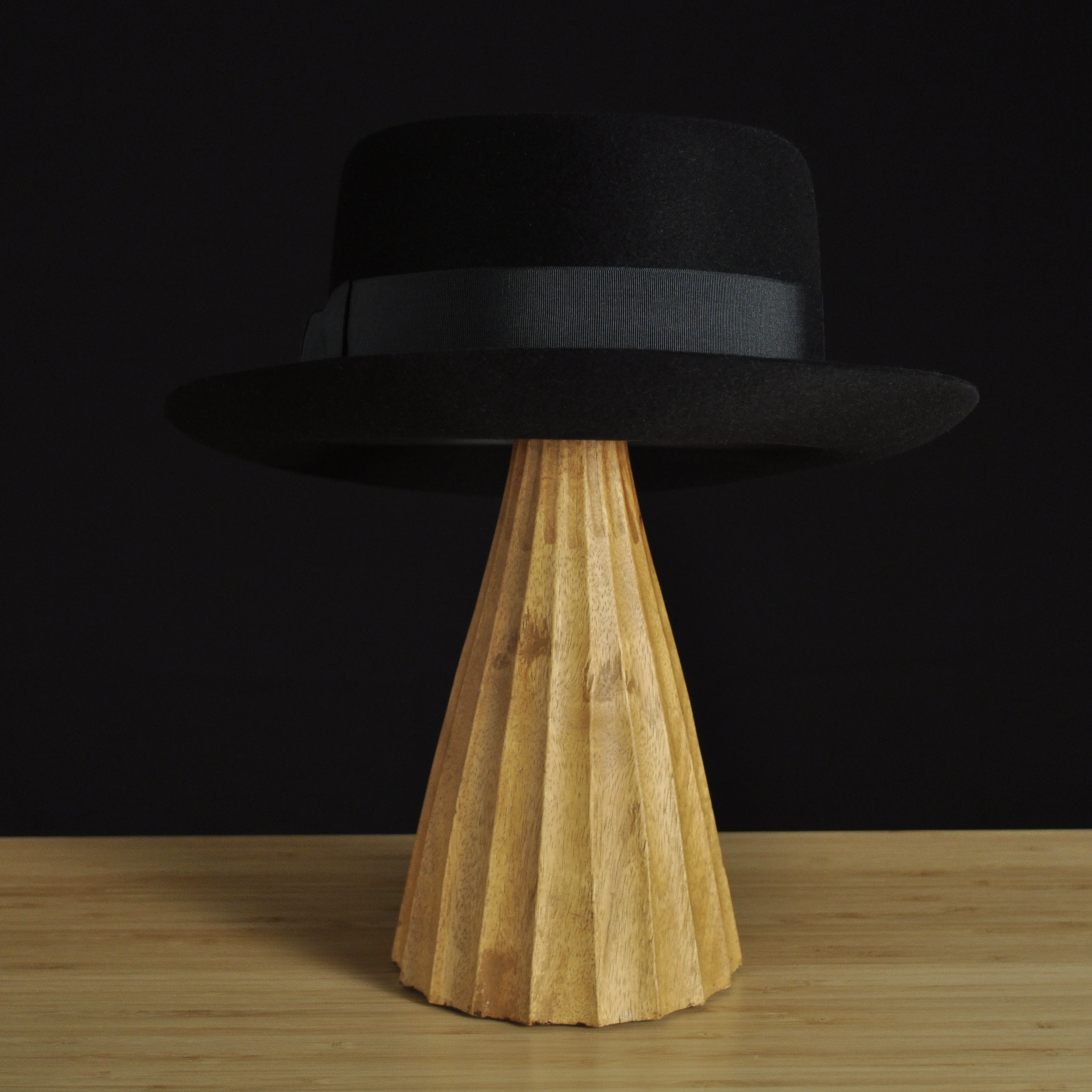 Back view of The Midtowner black felt fedora with a clean tapered crown, medium snap brim, and matching black grosgrain ribbon with classic bow.