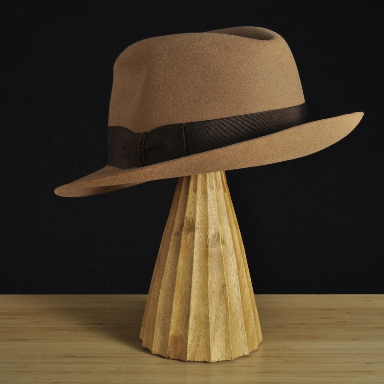 Three-quarter rear left view of The Vendômer tan felt fedora with a softly pinched crown, medium snap brim, and dark brown grosgrain ribbon with classic bow.
