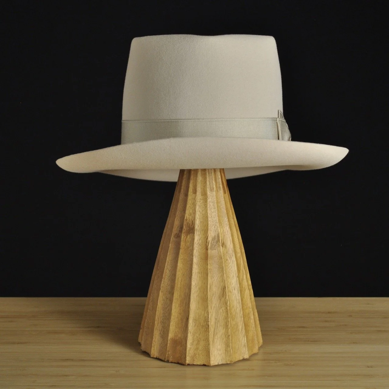 Rear view of The Vintner ivory felt fedora with a softly pinched crown, medium snap brim, and matching ivory grosgrain ribbon with classic double bow.