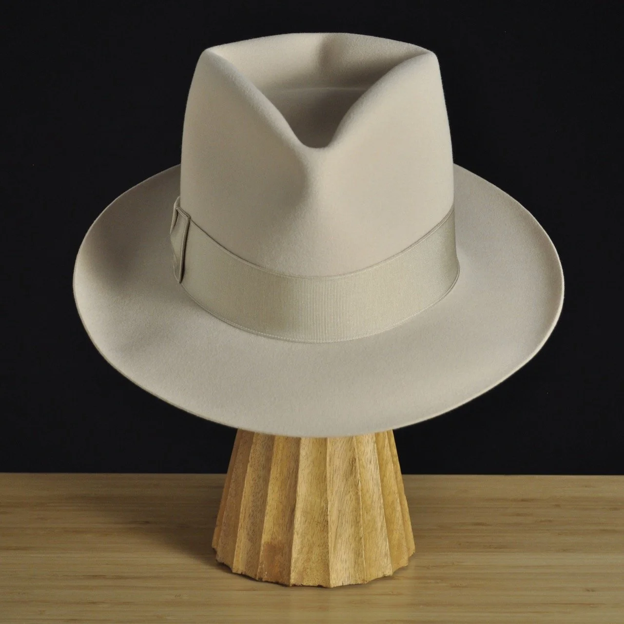 Front right view of The Vintner ivory felt fedora with a softly pinched crown, medium snap brim, and matching ivory grosgrain ribbon with classic double bow.