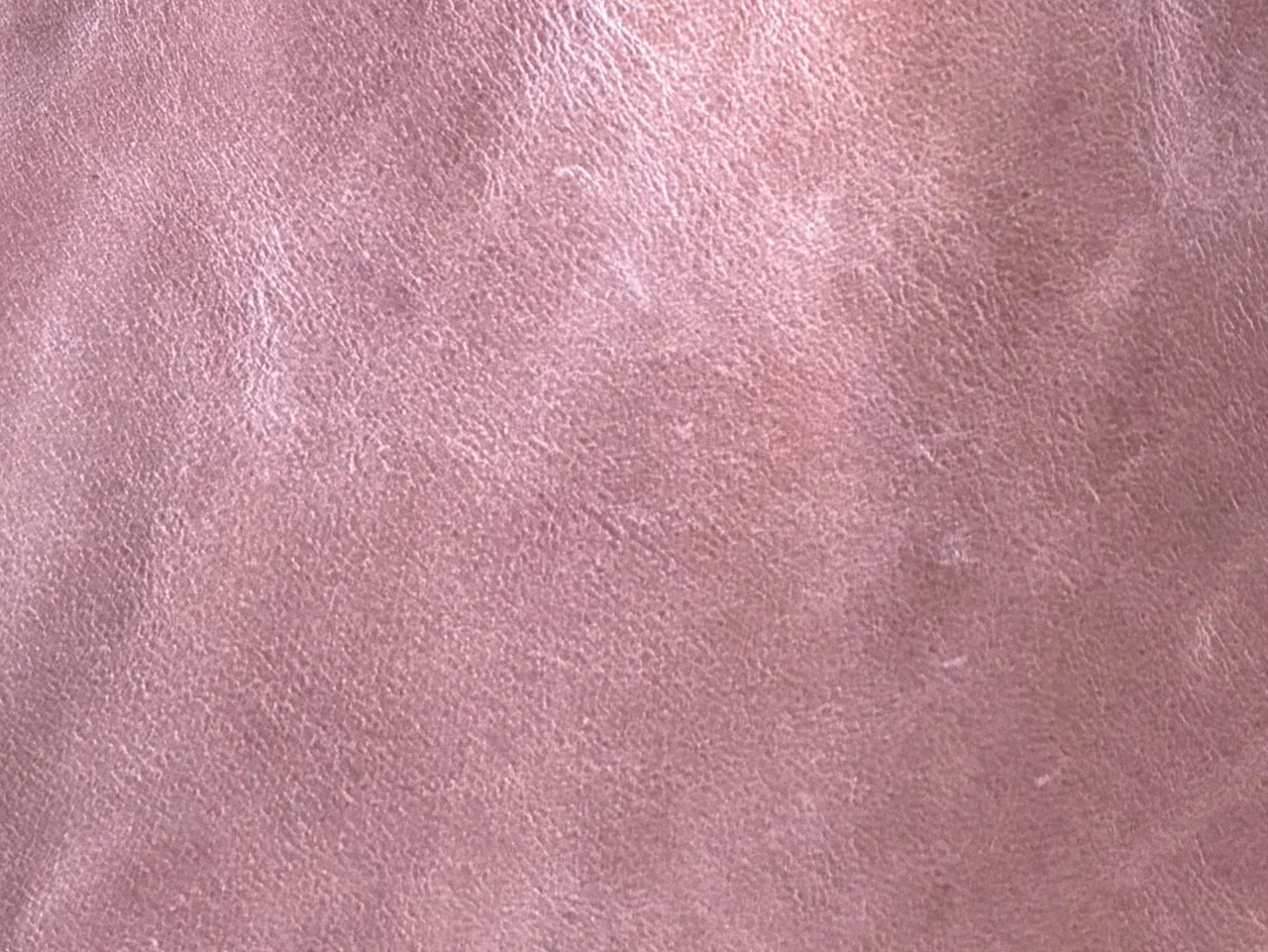 Close-up of pink textured leather surface.