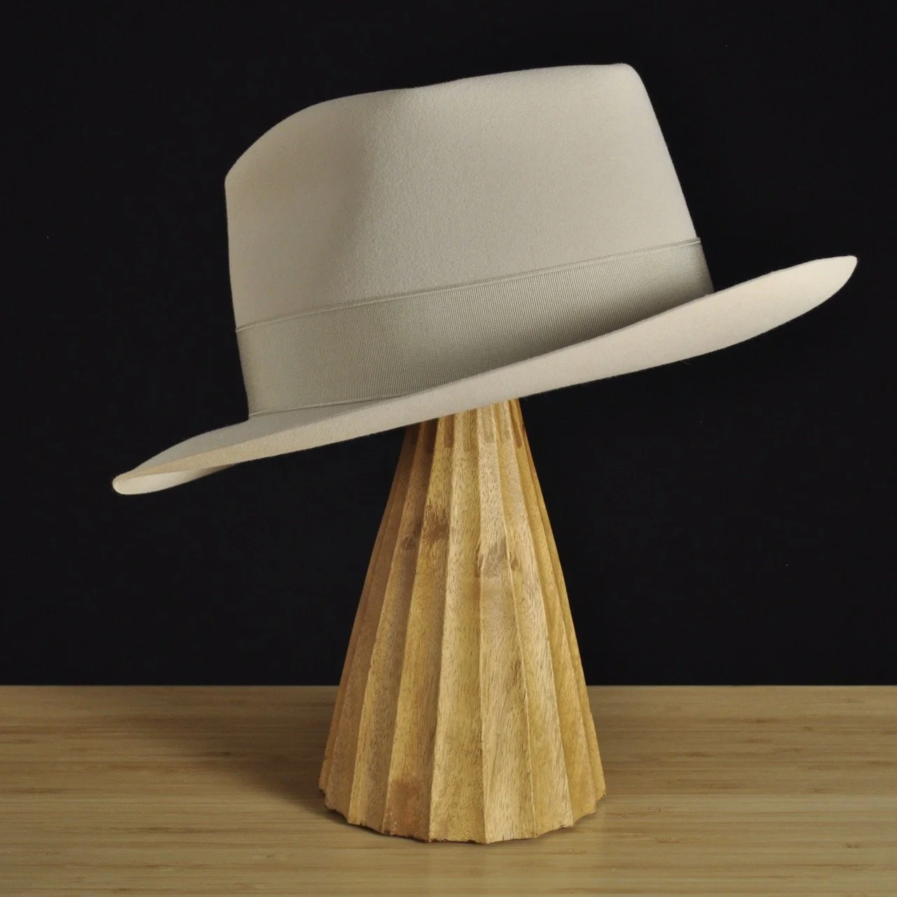 Three-quarter rear right view of The Vintner ivory felt fedora with a softly pinched crown, medium snap brim, and matching ivory grosgrain ribbon with classic double bow.