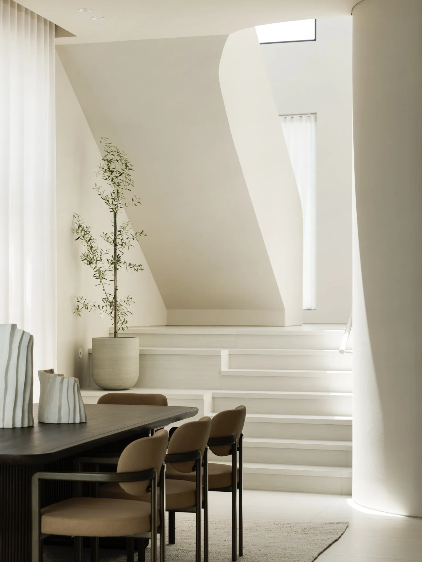 Abbotsford // the modern staircase, illuminated by natural light streaming through skylights, creates a serene and inviting atmosphere. 

We created a soft colour palette along with sleek lines to reflect a minimalist aesthetic, enhancing the spaciou