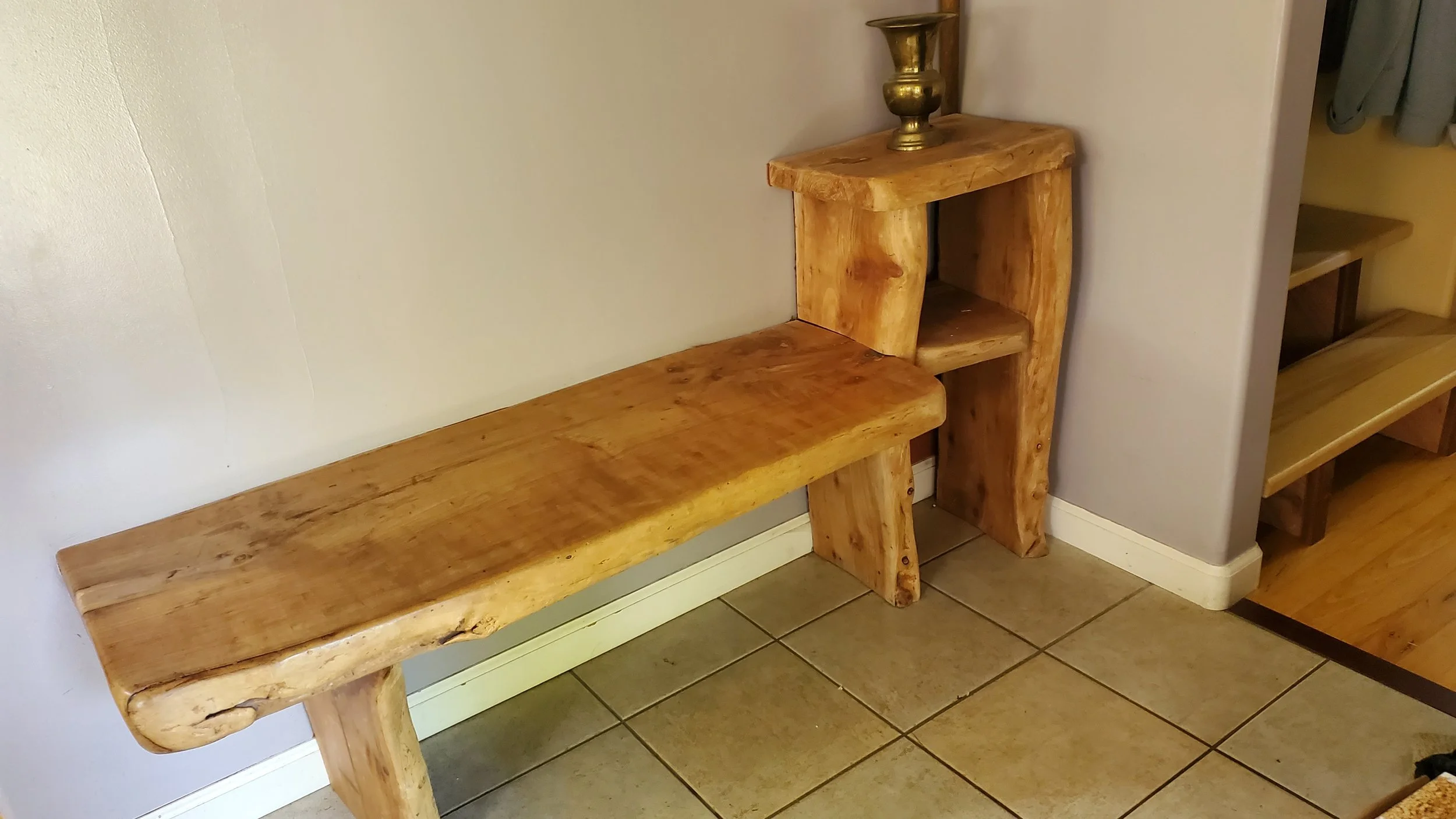 Entrance bench made from  an old Cherry tree that died after many years of providing shade and cherries in our yard.