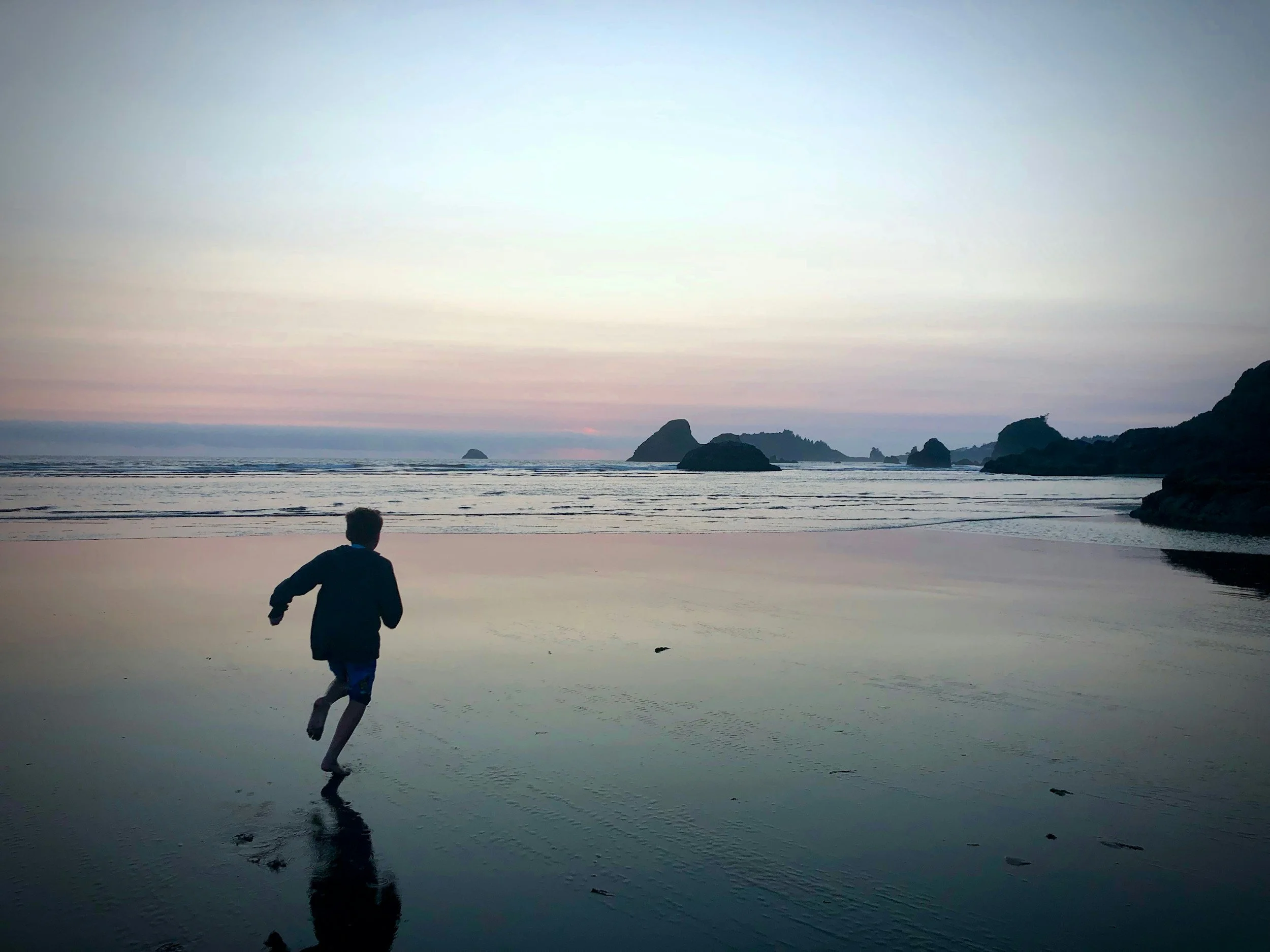 Child running alone on a beach, representing the quiet loneliness of childhood emotional neglect