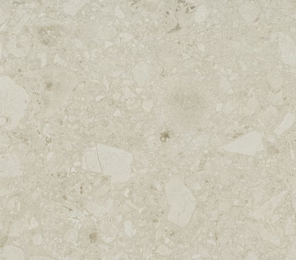 Close-up of a beige marble or limestone surface with natural veining and small patches