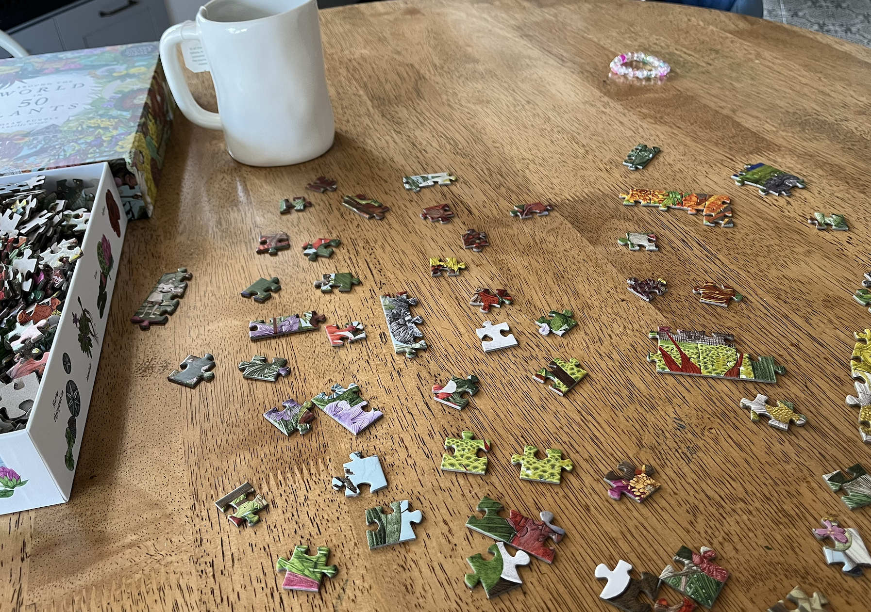 puzzle pieces are scattered across a wooden table top