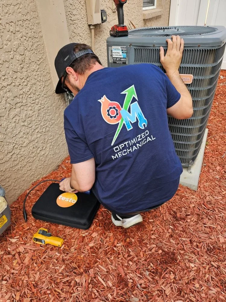 Ken Miller servicing an AC unit