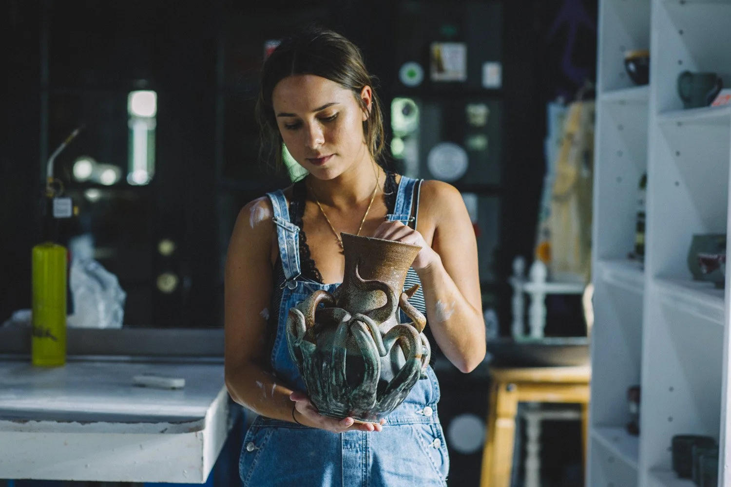 Artist Haley holding handmade octopus vase