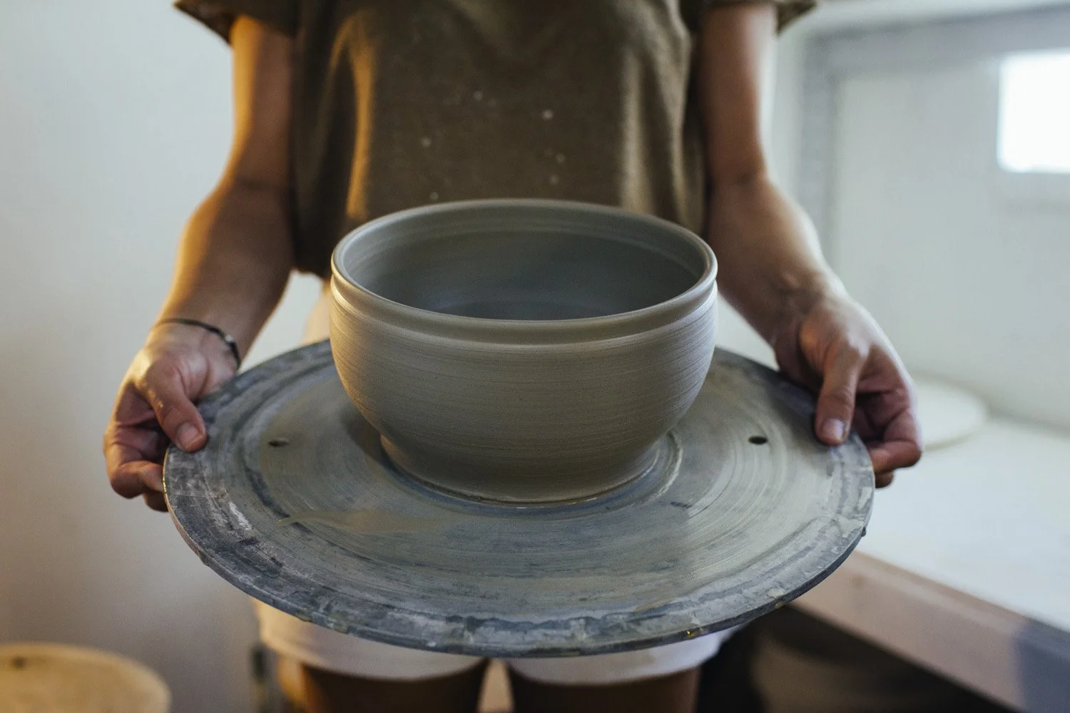 Haley Melcher holding wheel thrown bowl