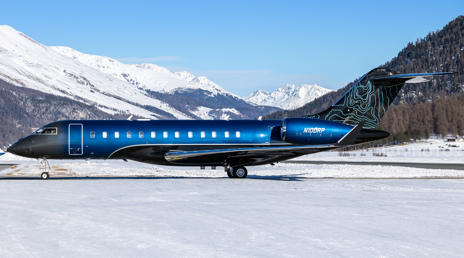 ACD | Alicia Cheung Design custom painted this jet exterior in a deep electric blue with an ombré fade and a topographic tailfin graphic, creating a striking and personal statement perfect for travel at altitude.