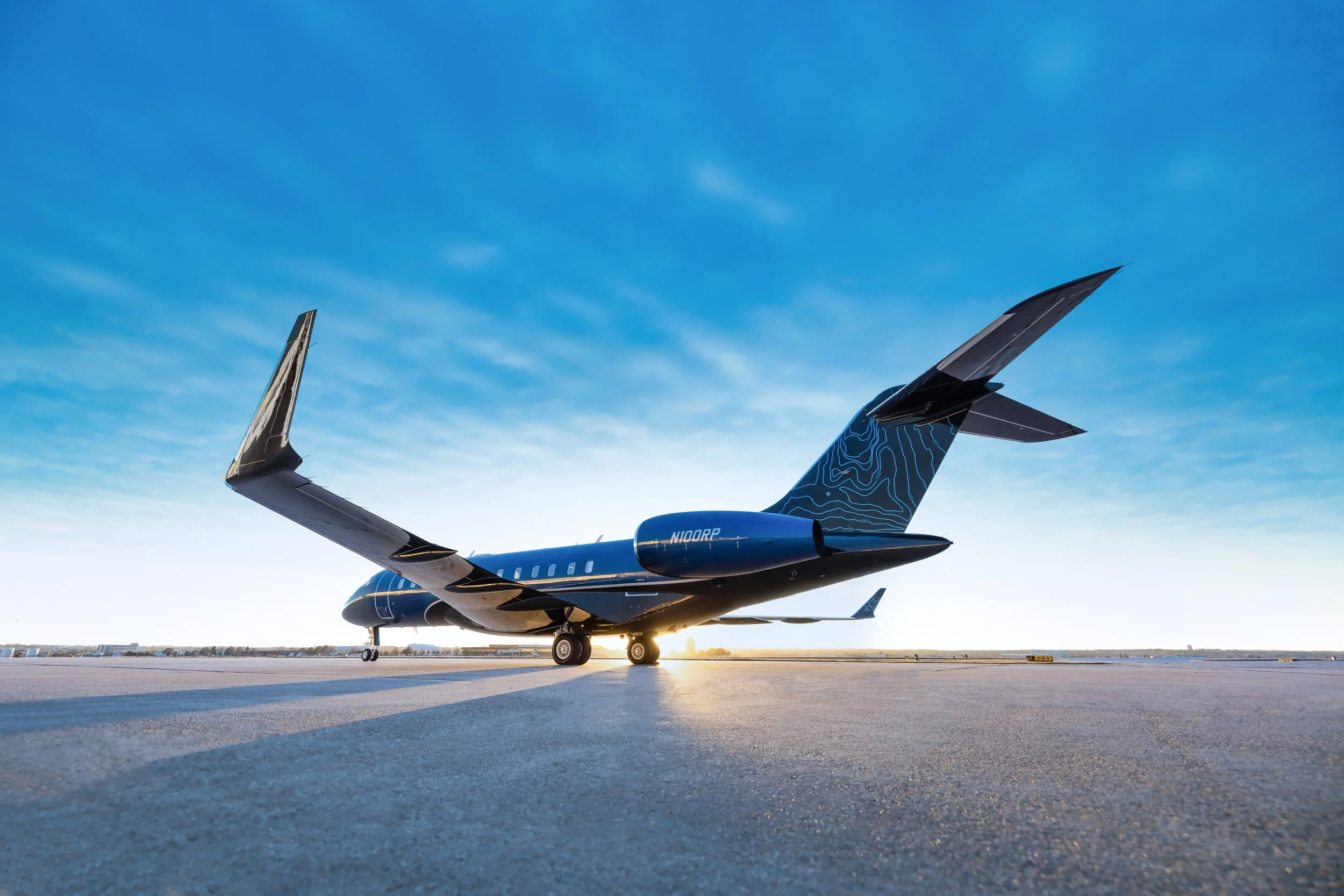 ACD | Alicia Cheung Design custom painted this jet exterior in a deep electric blue with an ombré fade and a topographic tailfin graphic, creating a striking and personal statement perfect for travel at altitude.