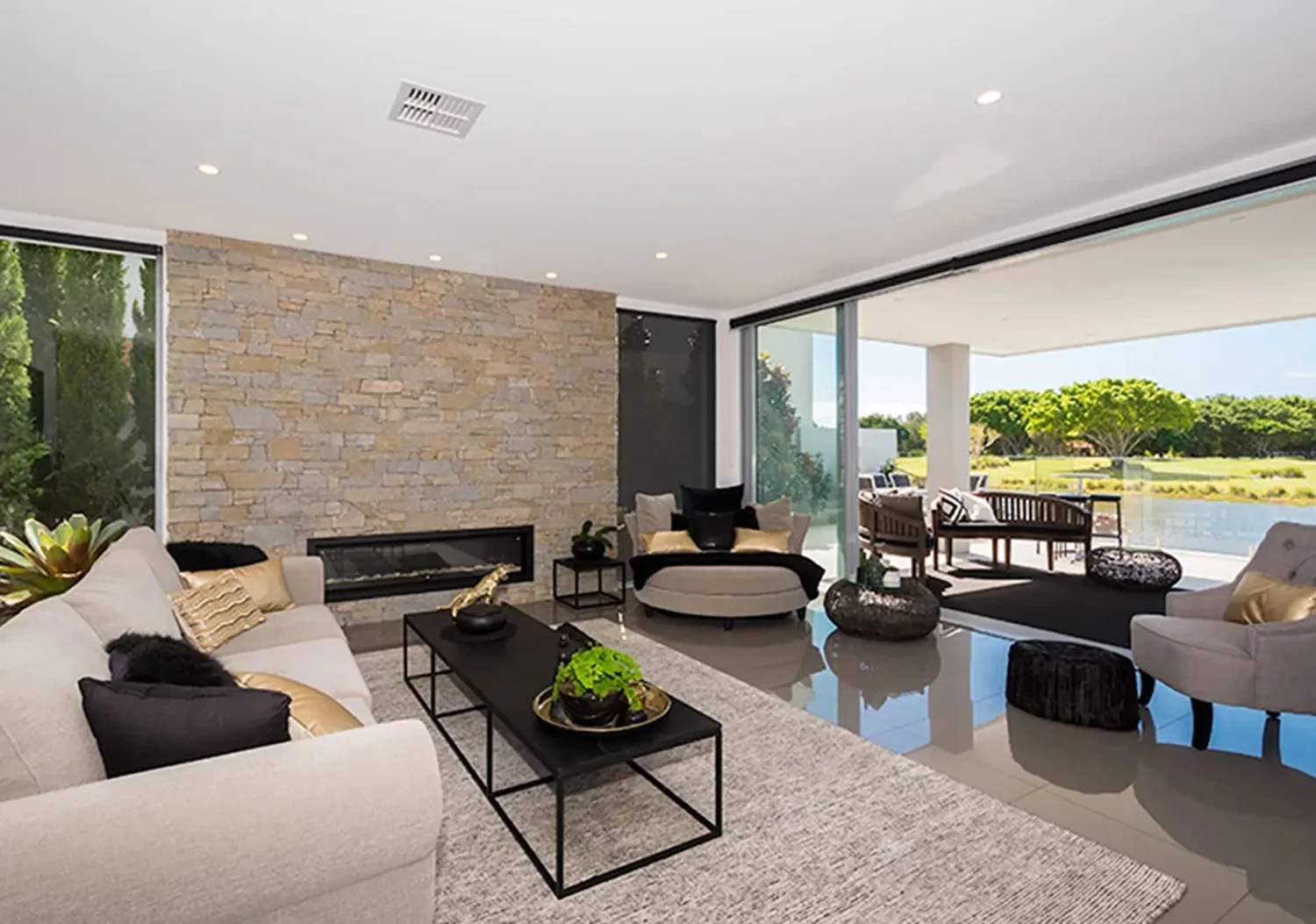 The sun setting through a dense forest.