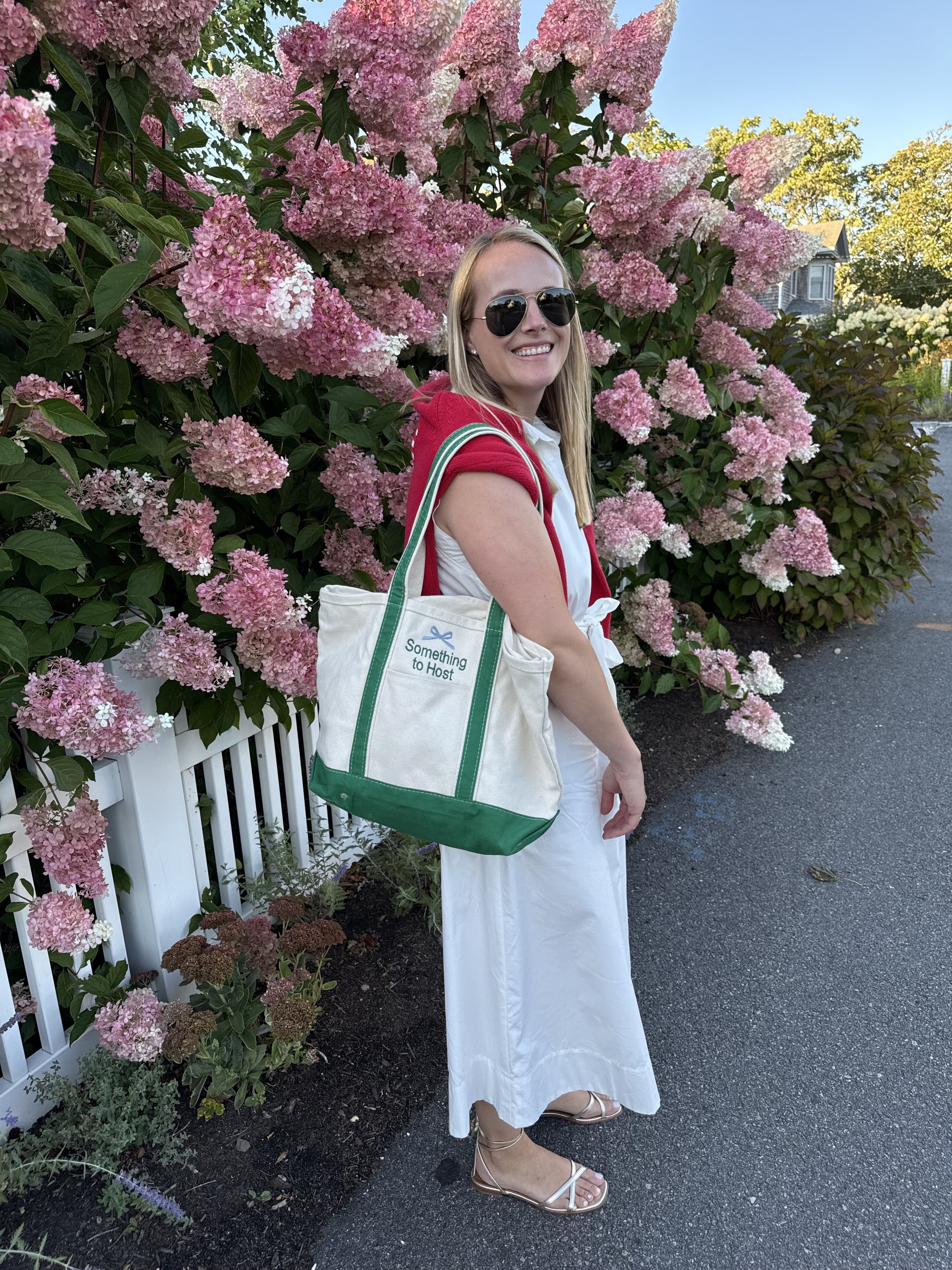 Stephanie from Something to Host with a branded STH tote.