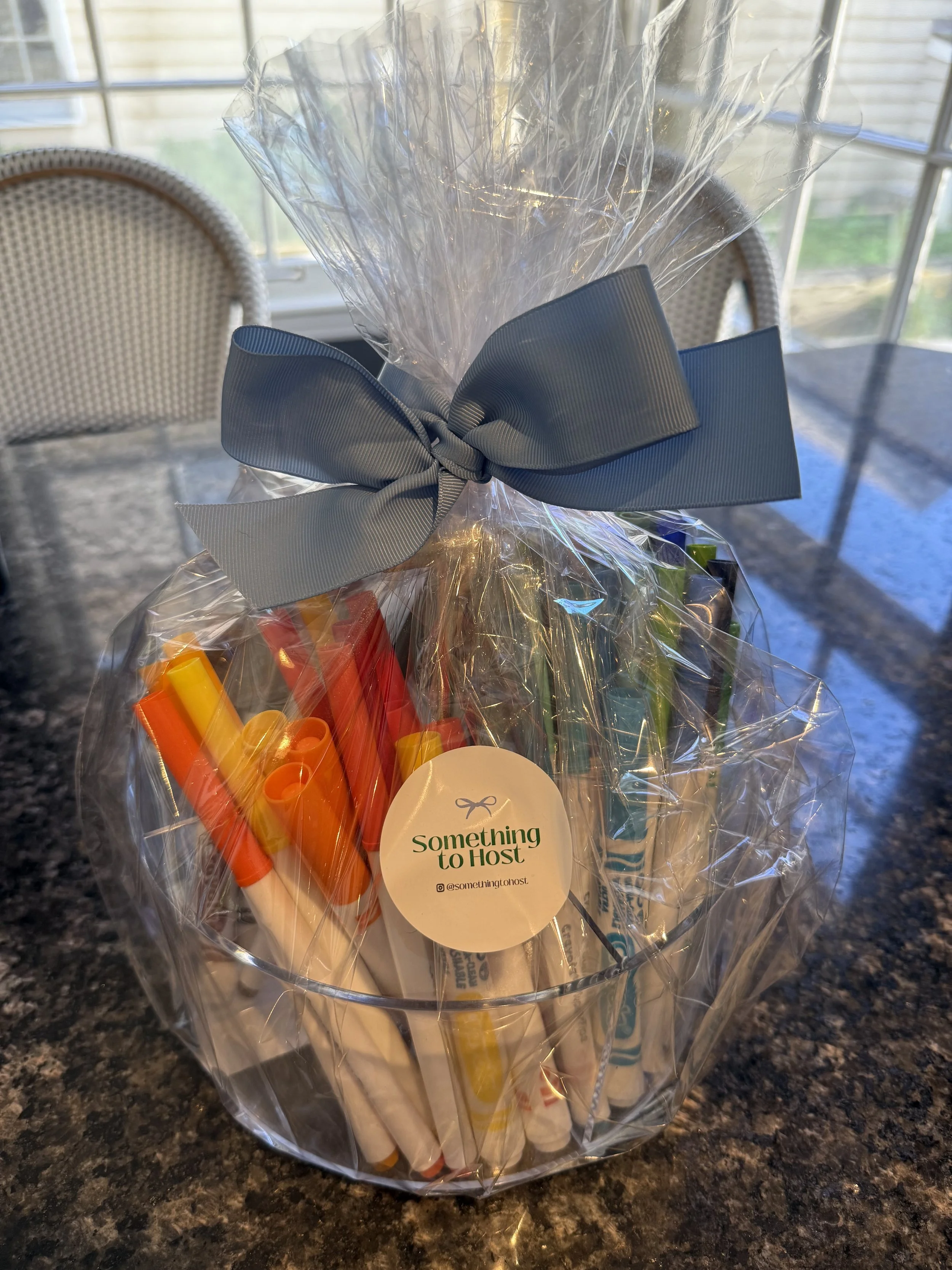 Markers in an acrylic organizer wrapped in a Something to Host goodie bag