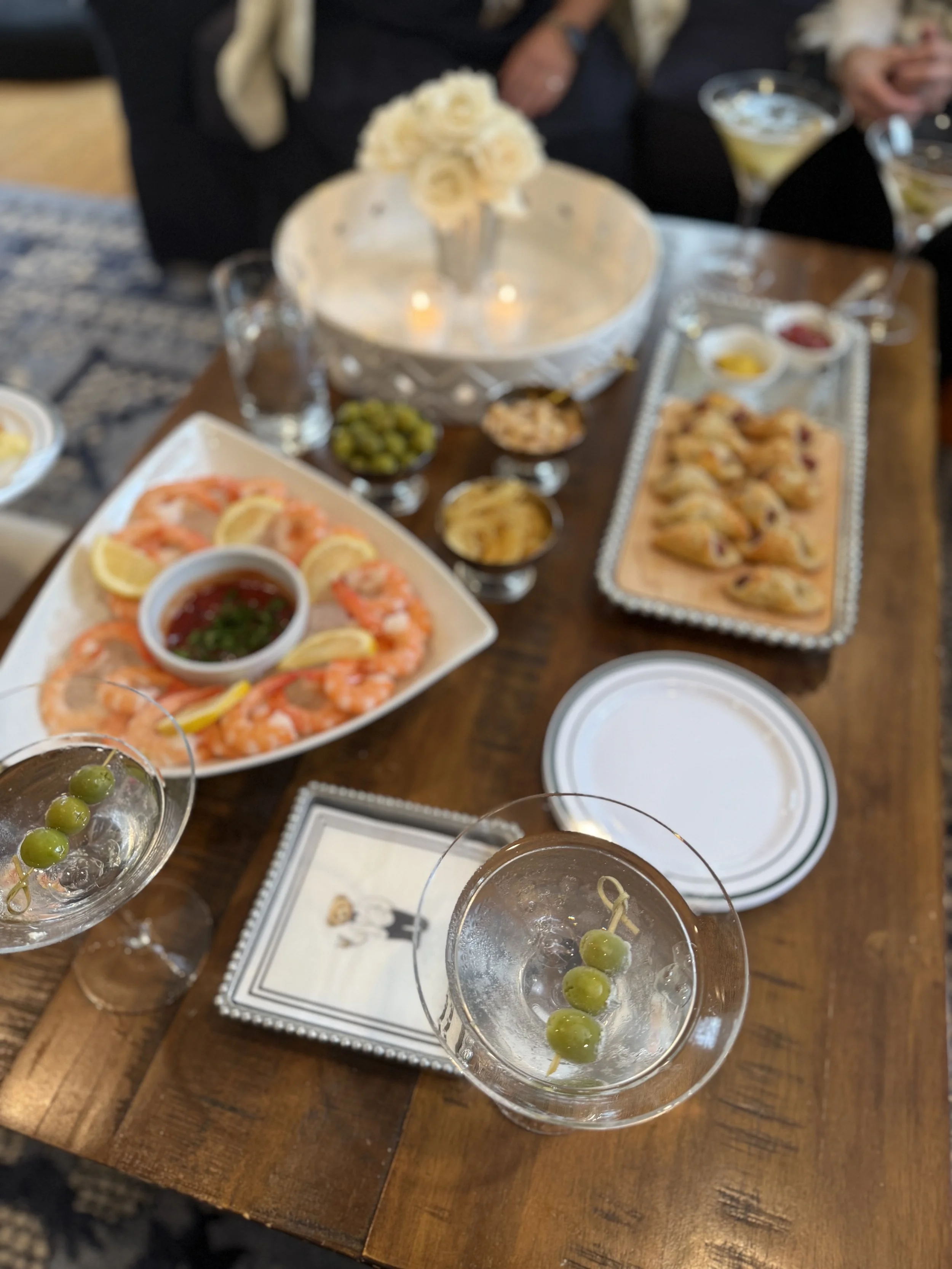 Coffee table with appetizers and drinks.