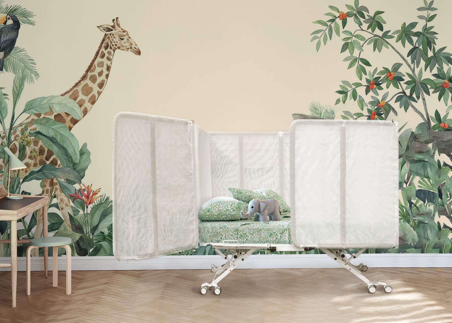 Children's room with jungle-themed wallpaper, featuring giraffe and plants, a crib with floral bedding, stuffed elephant toy, and a small desk with a lamp and chair.