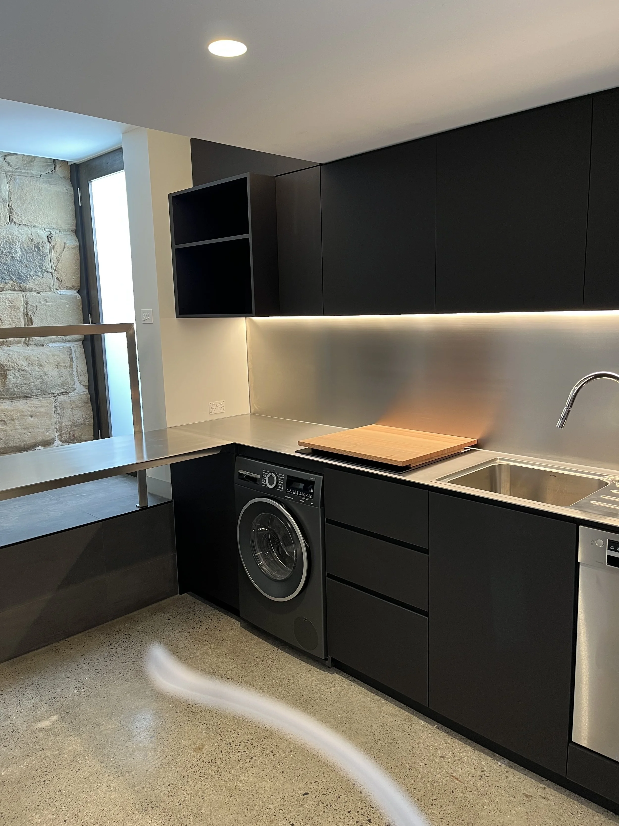 5mm stainless steel plate benchtops, with a brushed finish, in a laundry/kitchenette installed at a private residence at North Hobart.