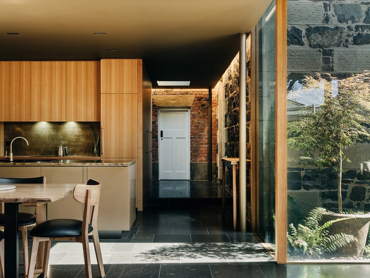 Private residence Hobart. Brass Benchtop and splashback with aged finish. Architect - Bence Mulcahy. Photo copyright - Adam Gibson.
