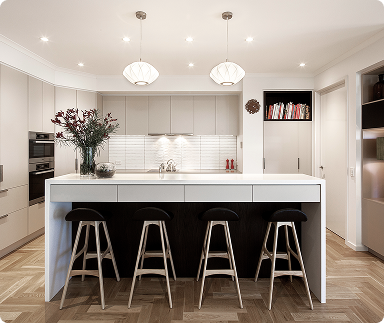 Modern kitchen with a white island, four black bar stools, beige cabinetry, and a white backsplash. Two pendant lights hang above the island, and a vase of flowers is on the counter.