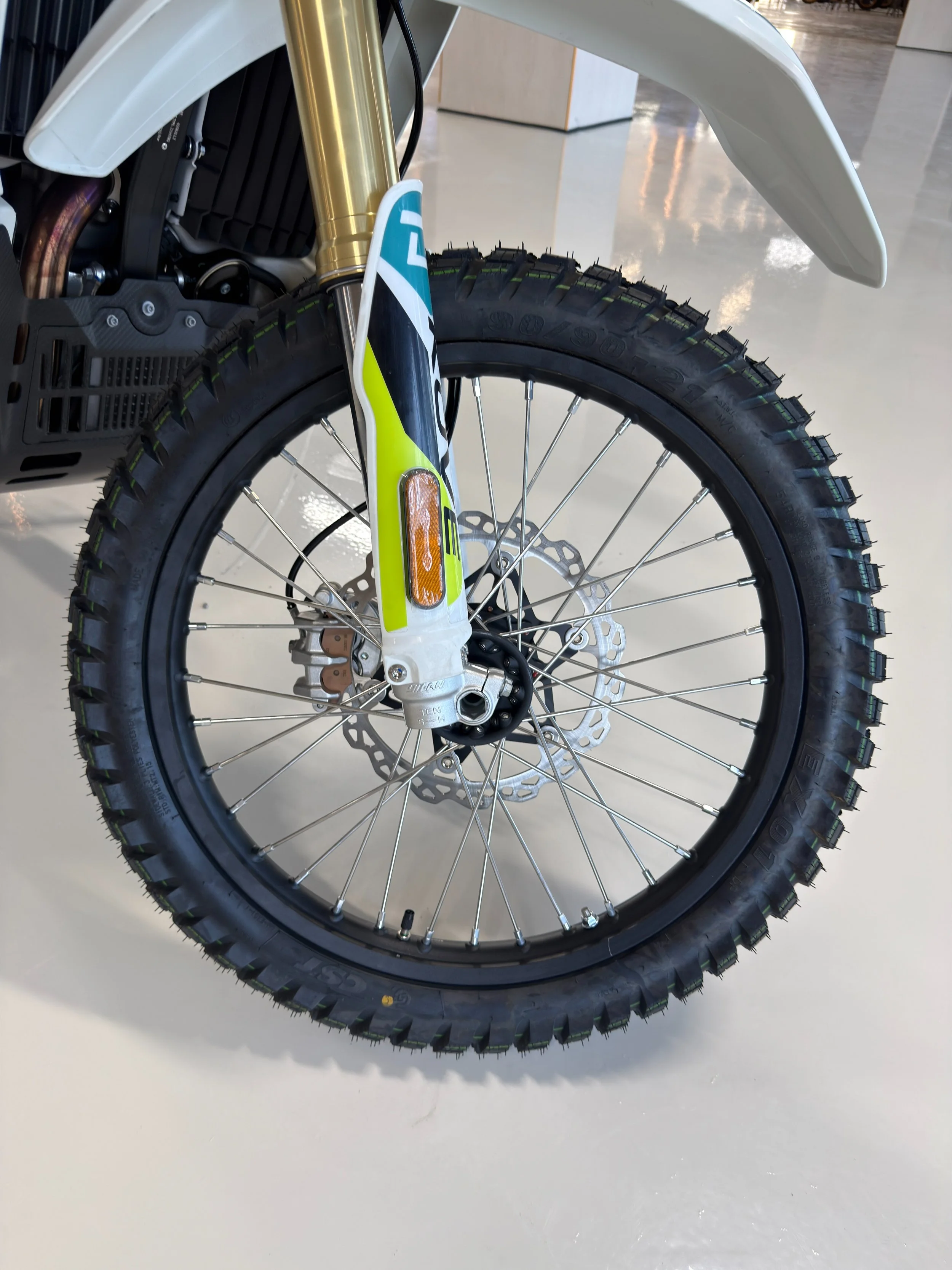 Close-up of a rally bike front wheel, tire, and suspension forks. KOVE Rally 450 RE