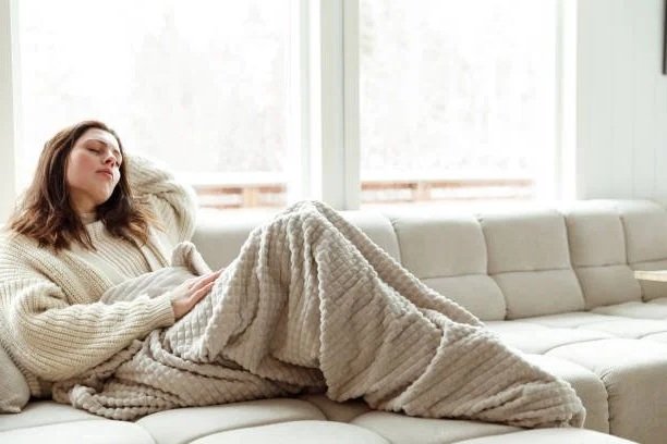 sick mom with mastitis on couch