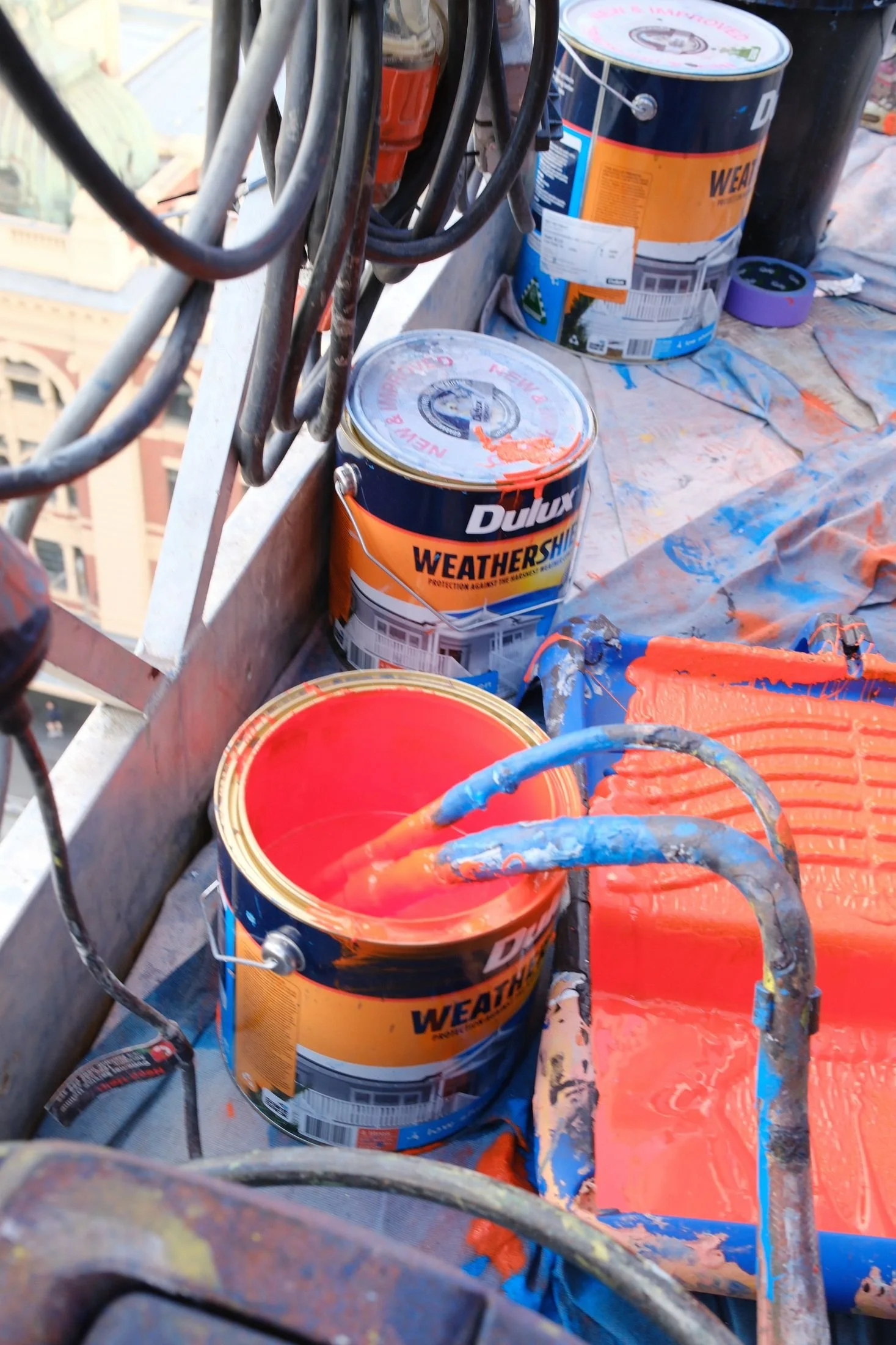 Paint tins and hoses on the swing stage