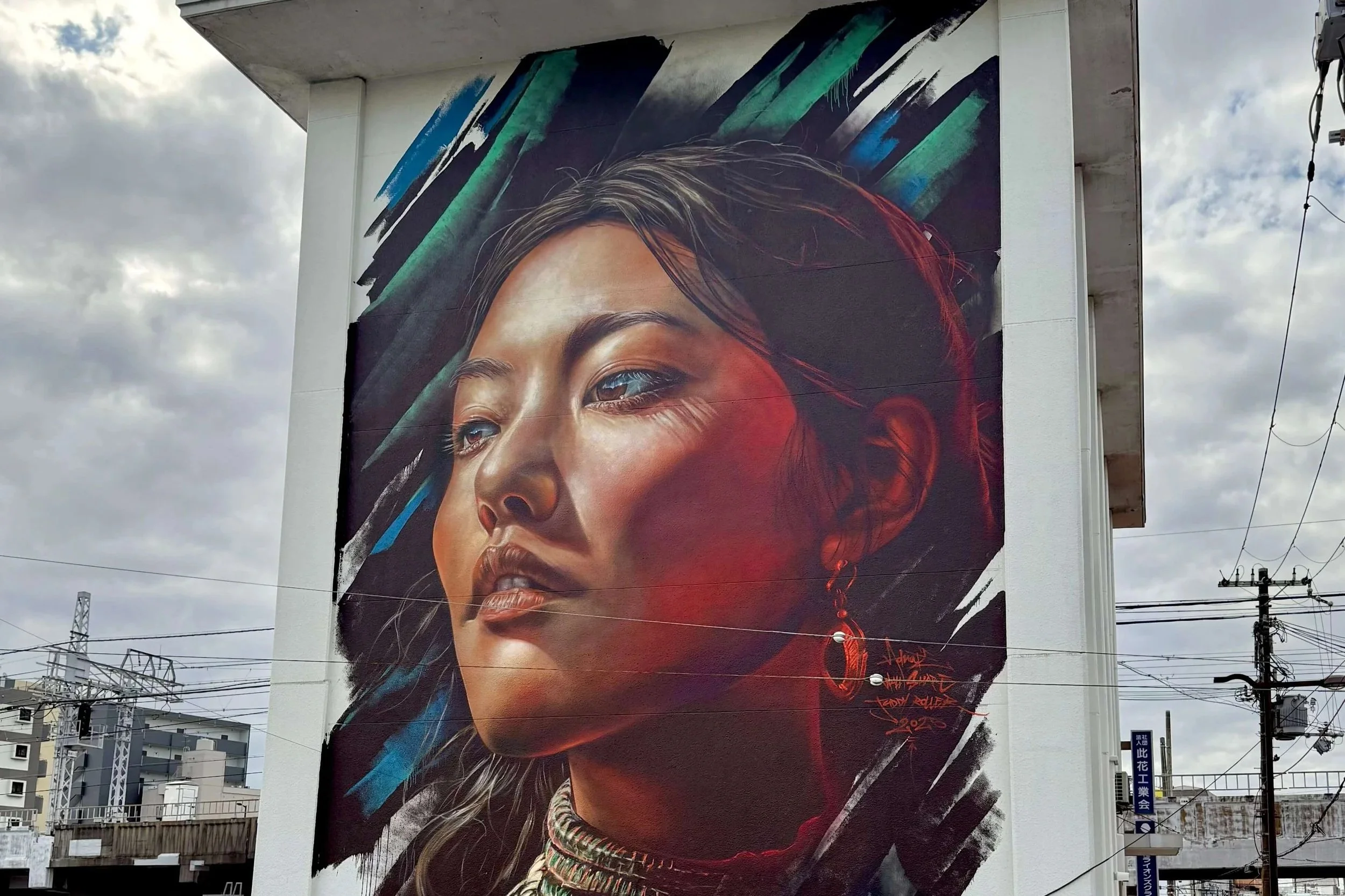 large scale street art mural of japanese woman looking towards the sky