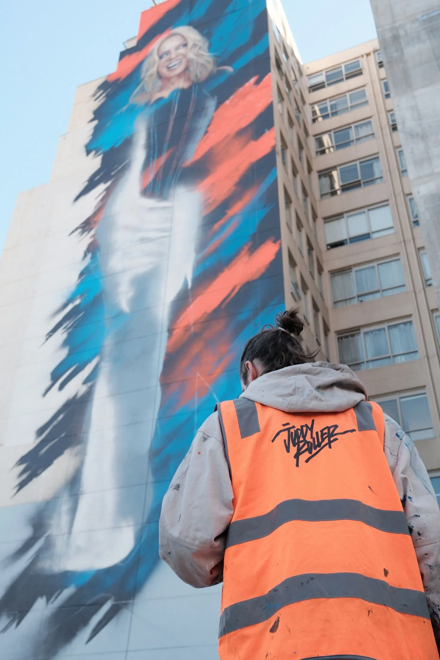 A Juddy Roller crew member looking up at the finished mural