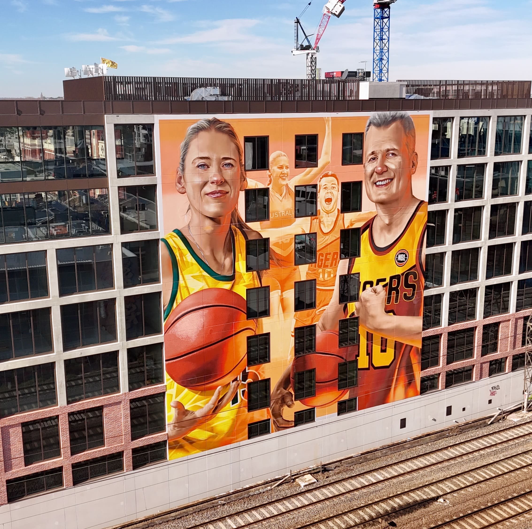 large scale mural artword depicting nbl starts lauren jackson and andrew gaze