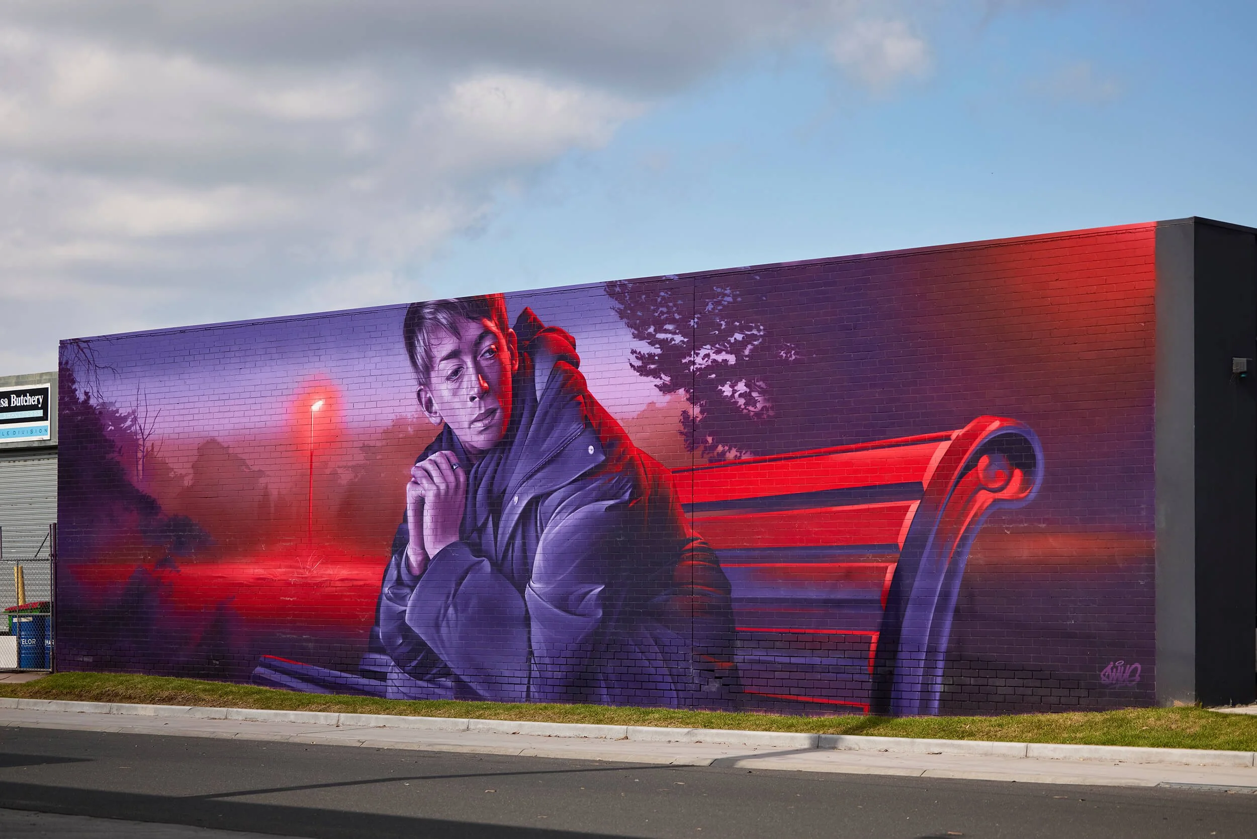 mural by artist smug depicts man sitting on chair contemplating