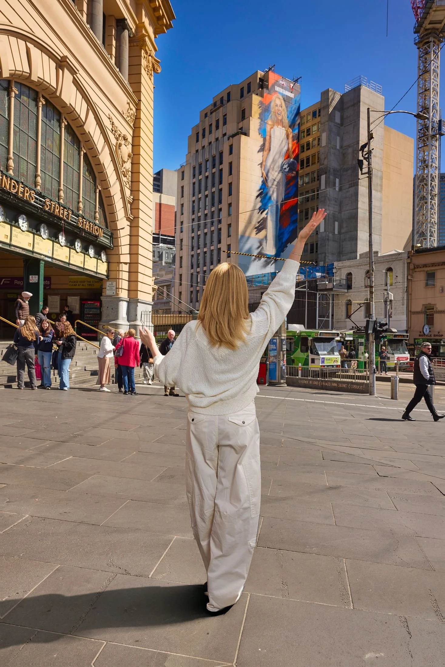 Kylie Minogue in front of her mural at Flinders Street