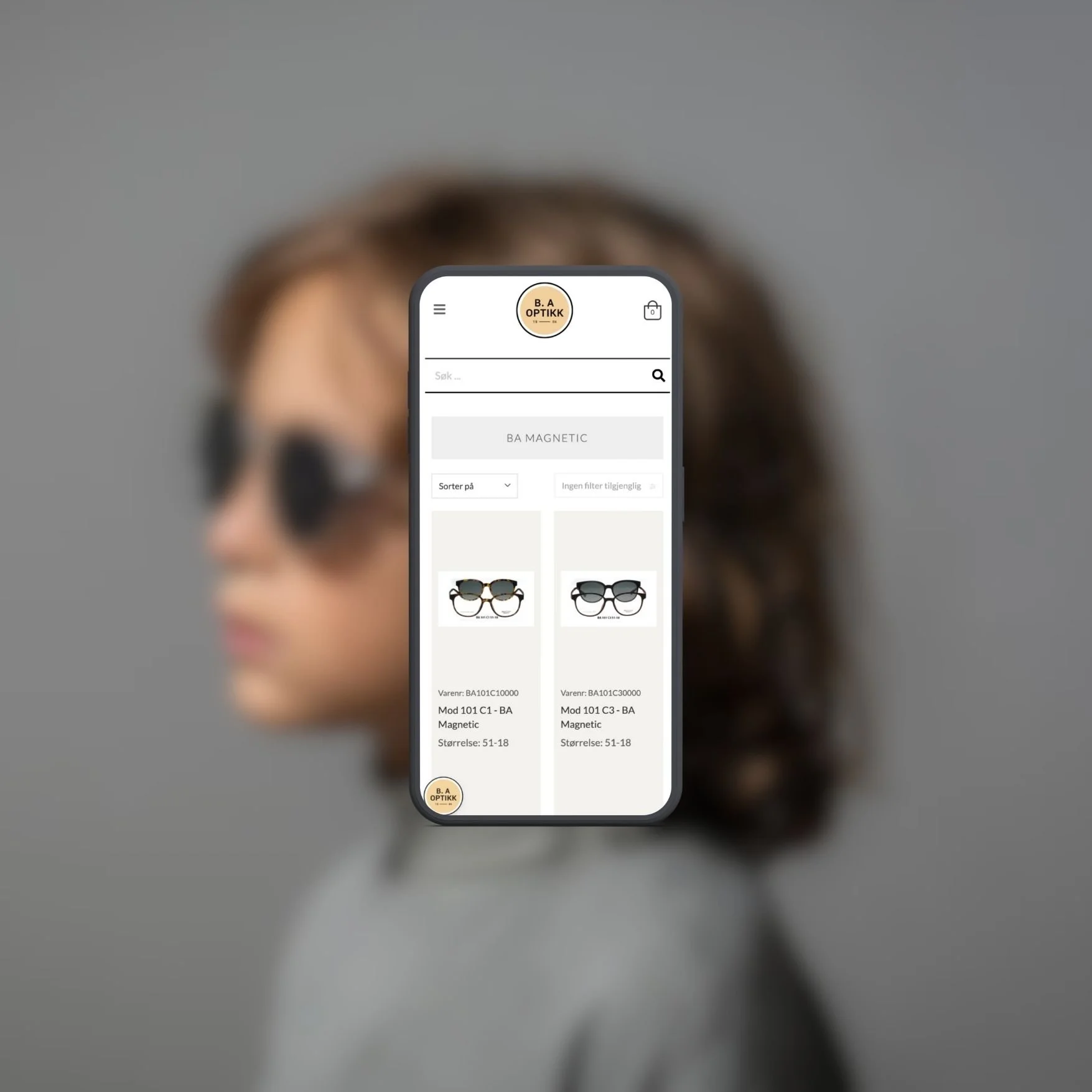 En kvinne med kort bølgete hår og solbriller viser frem en mobiltelefon med en nettside for optikk, hvor det er visning av to par briller til salg.