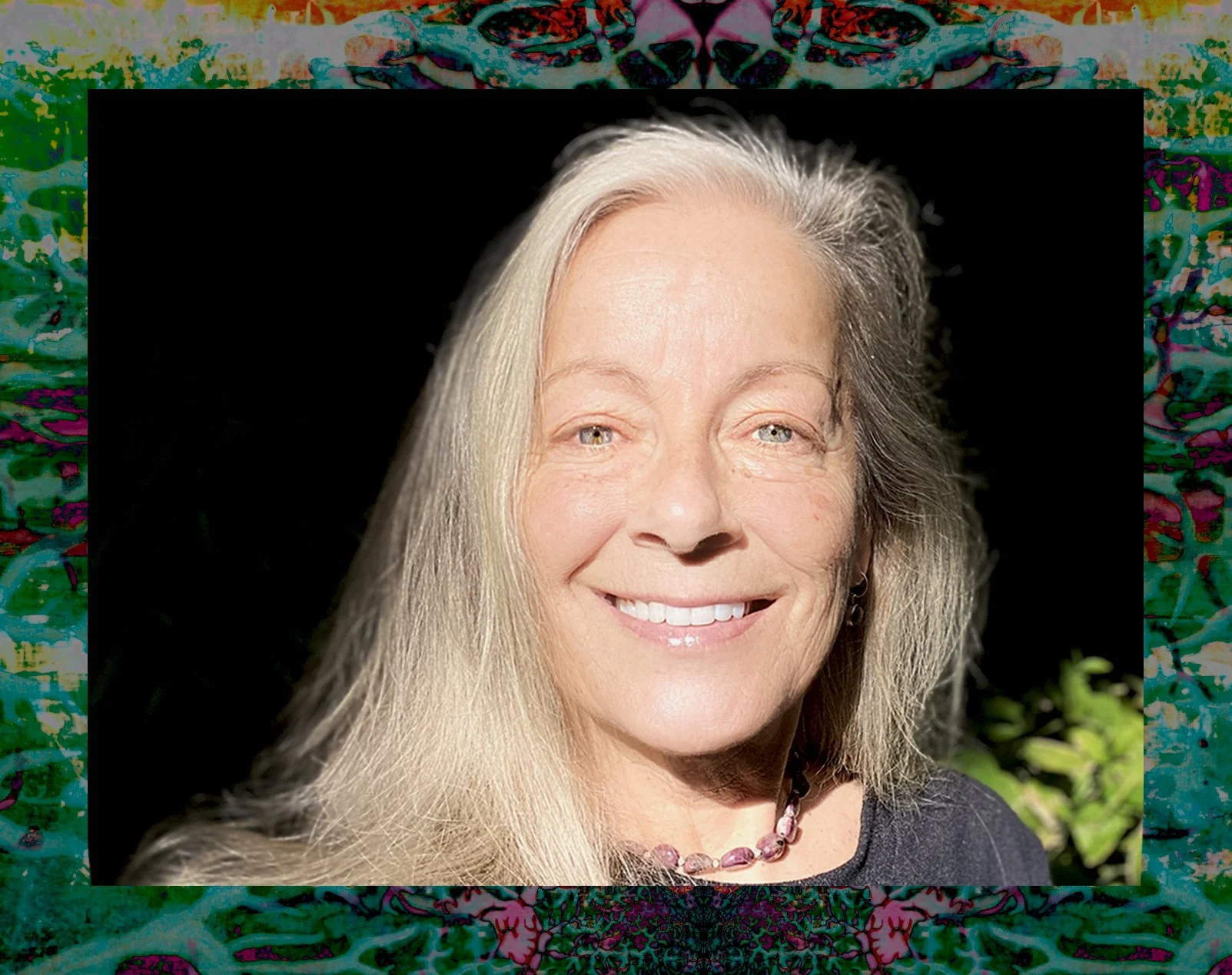 Tashia headshot picture in a garden in the sun.