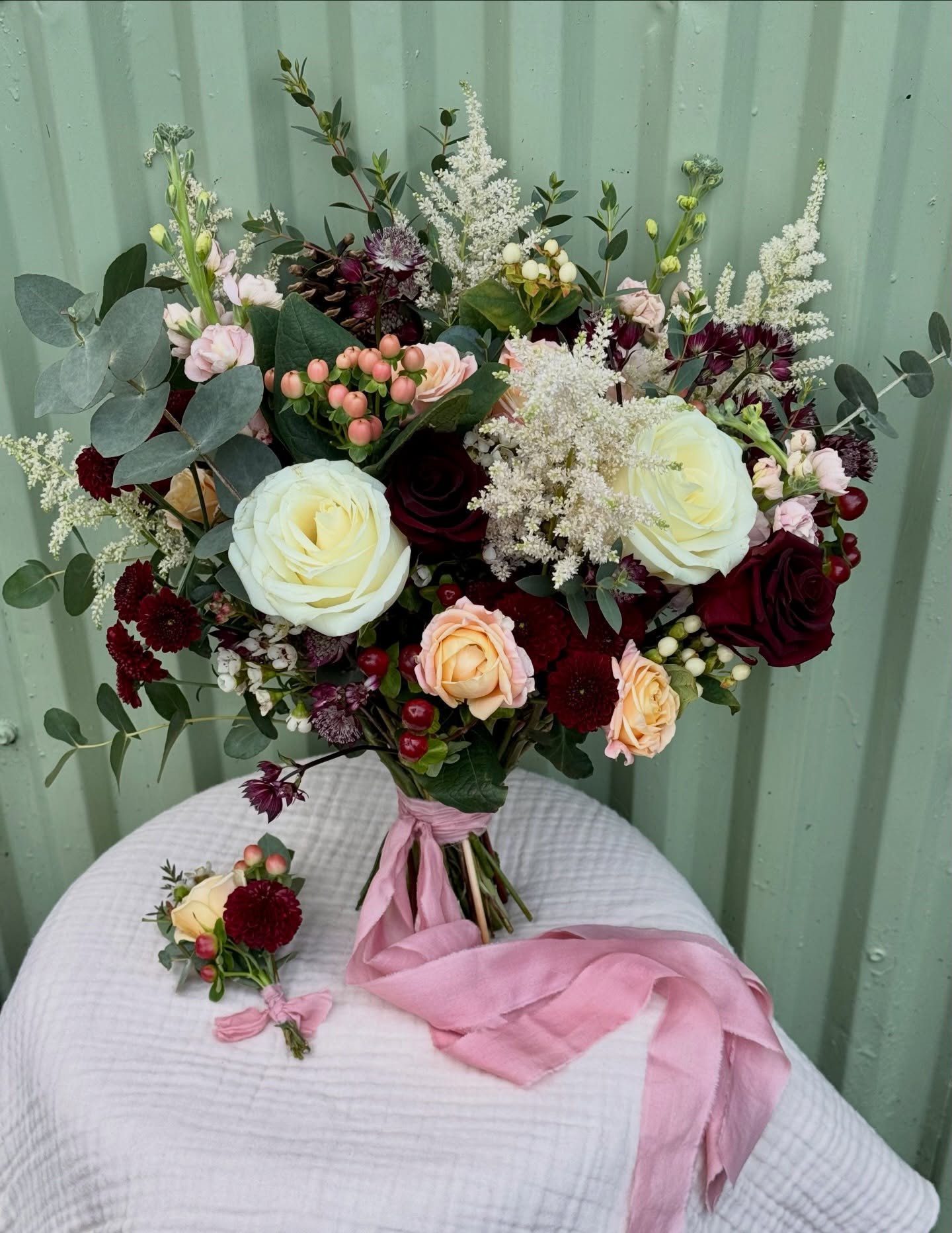 deep burgundy &amp; peachy pinks for rosie and cedric 🥀🍷🍑🌸

a bouquet and buttonhole created for a very special day just before Christmas. Rosie got in touch with a vision of rich burgundy tones which we paired with soft peachy and blush pinks an