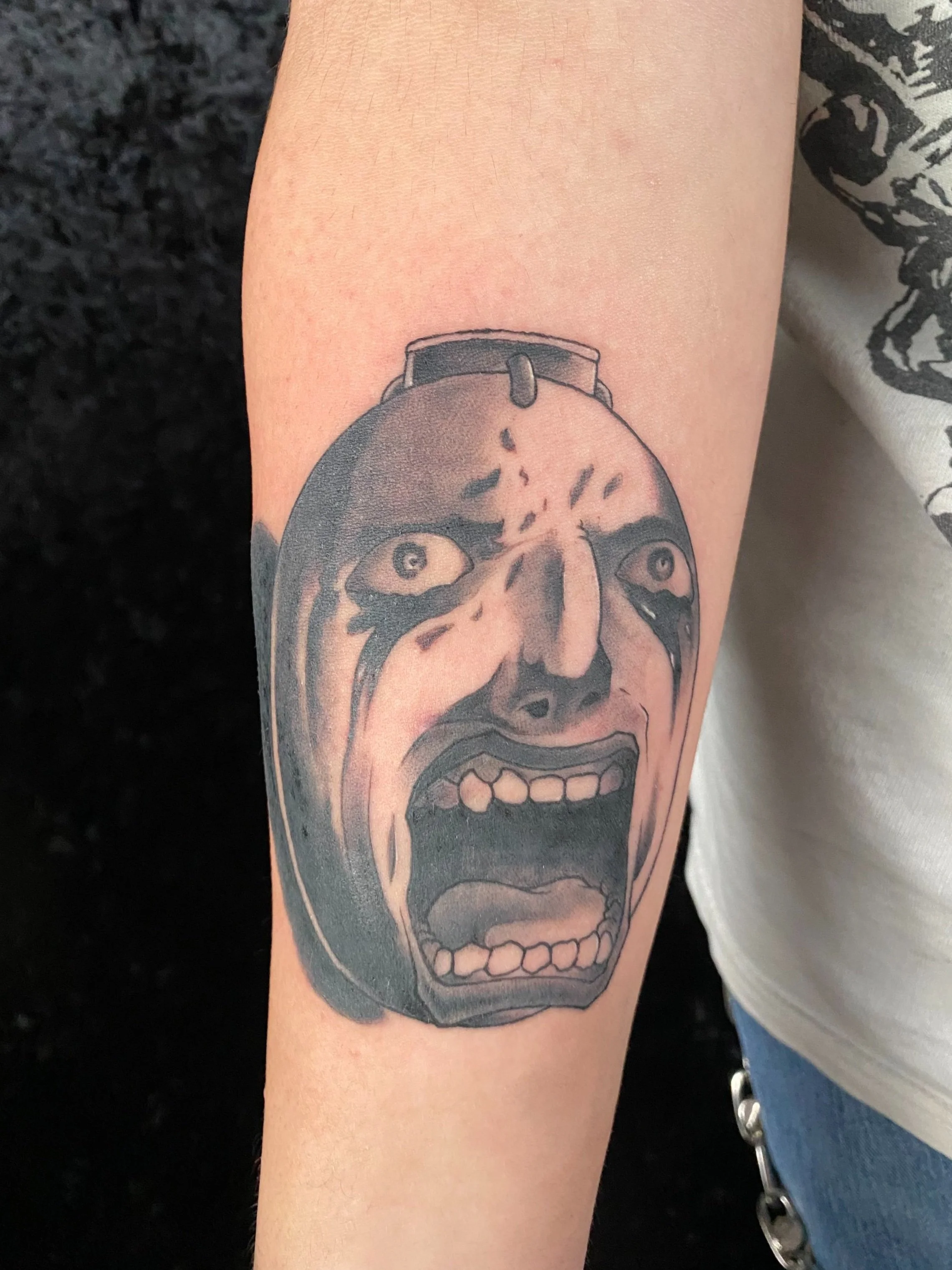 Anime tattoo, berserk tattoo, black and grey shading, smooth shading, crisp linework, sad face