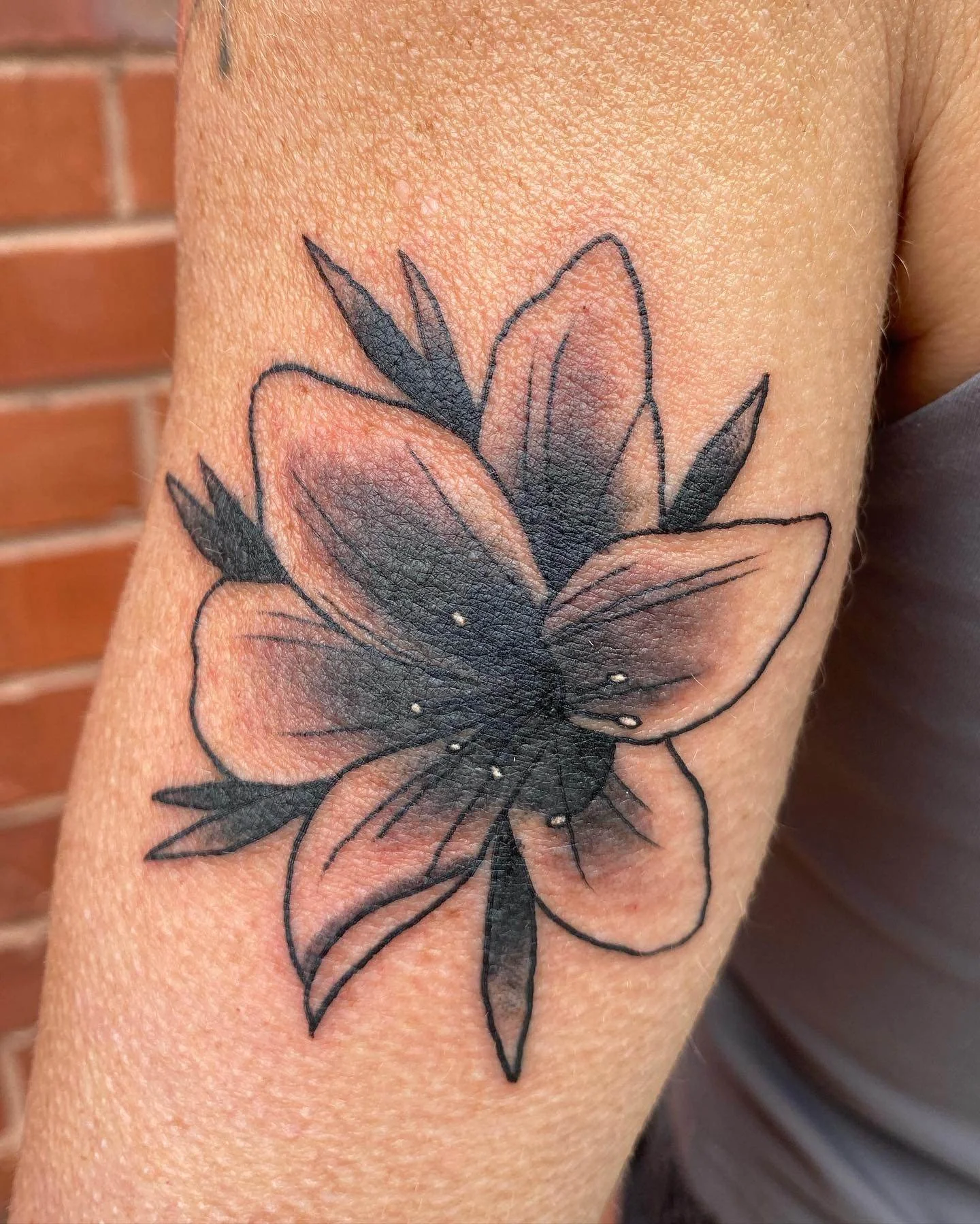 Black and grey floral tattoo