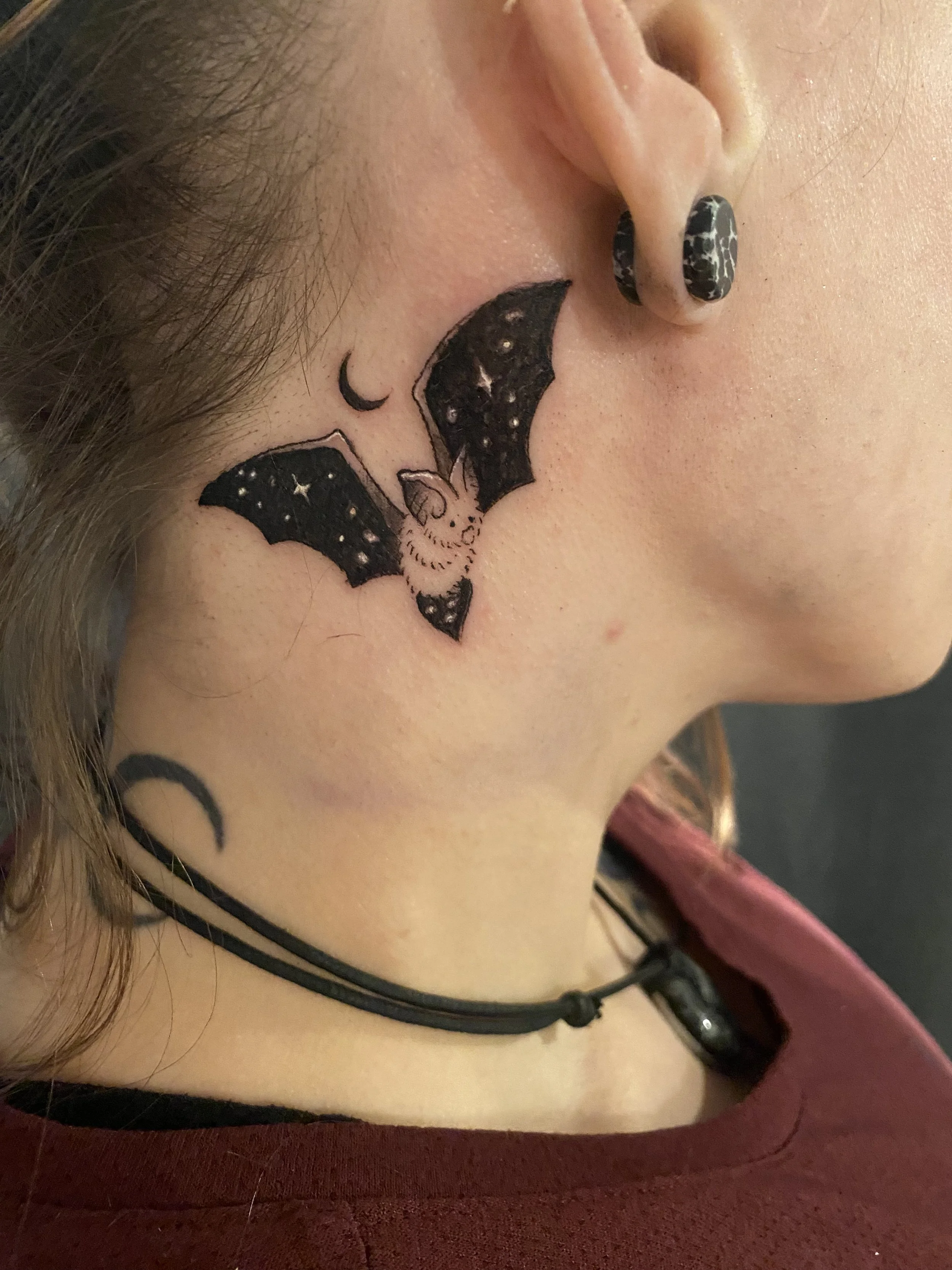 Miniature blackwork bad tattoo with saturated blacks and fineline details