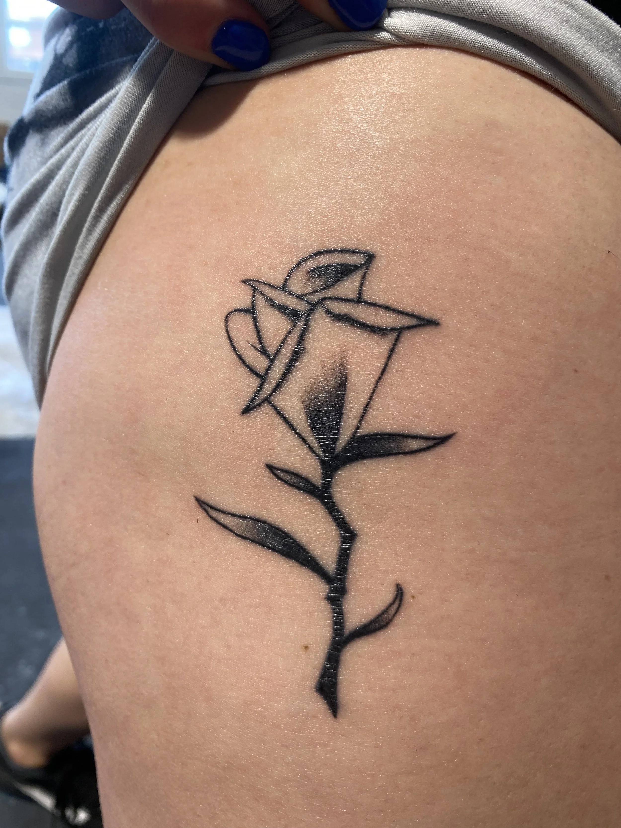 Minimalist linework rose tattoo