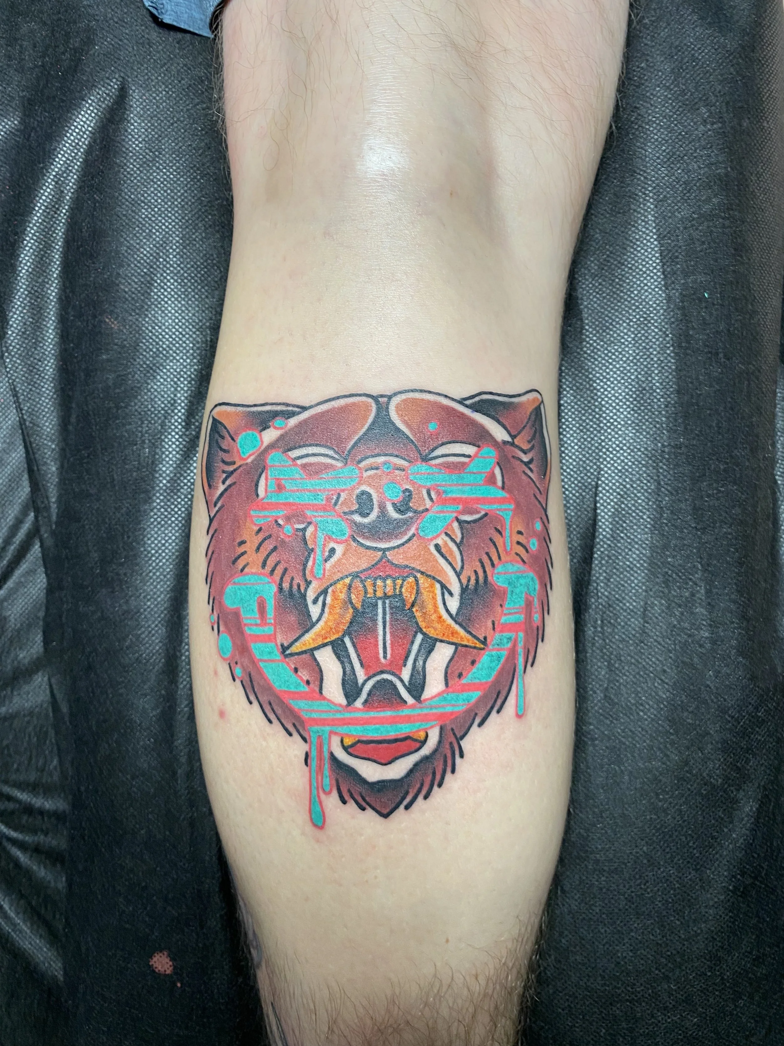 American Traditional color bear tattoo with psychedelic elements by Denver tattoo artist Joshua Socrates in RiNo.