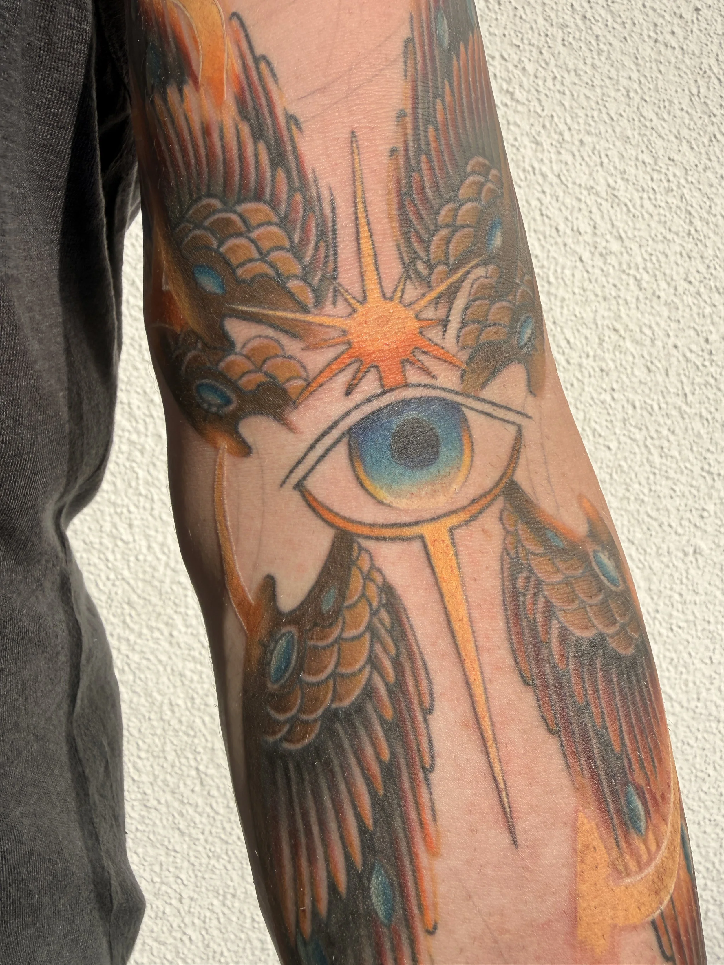 American Traditional-inspired seraphim (biblically accurate angel) tattoo with psychedelic elements by Denver tattoo artist Joshua Socrates in RiNo.