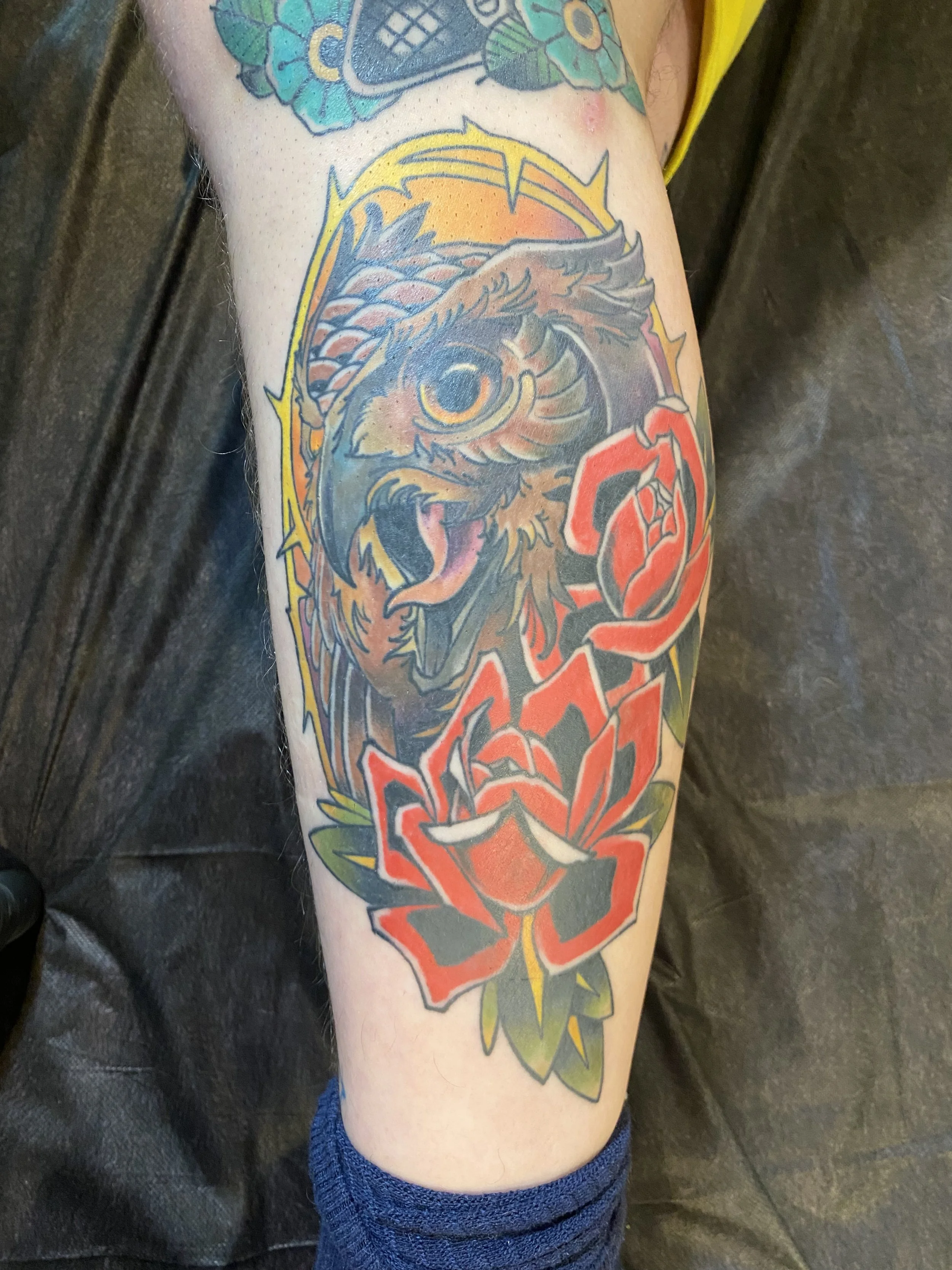 American Traditional-inspired owl and rose tattoo by Denver tattoo artist Joshua Socrates in RiNo.