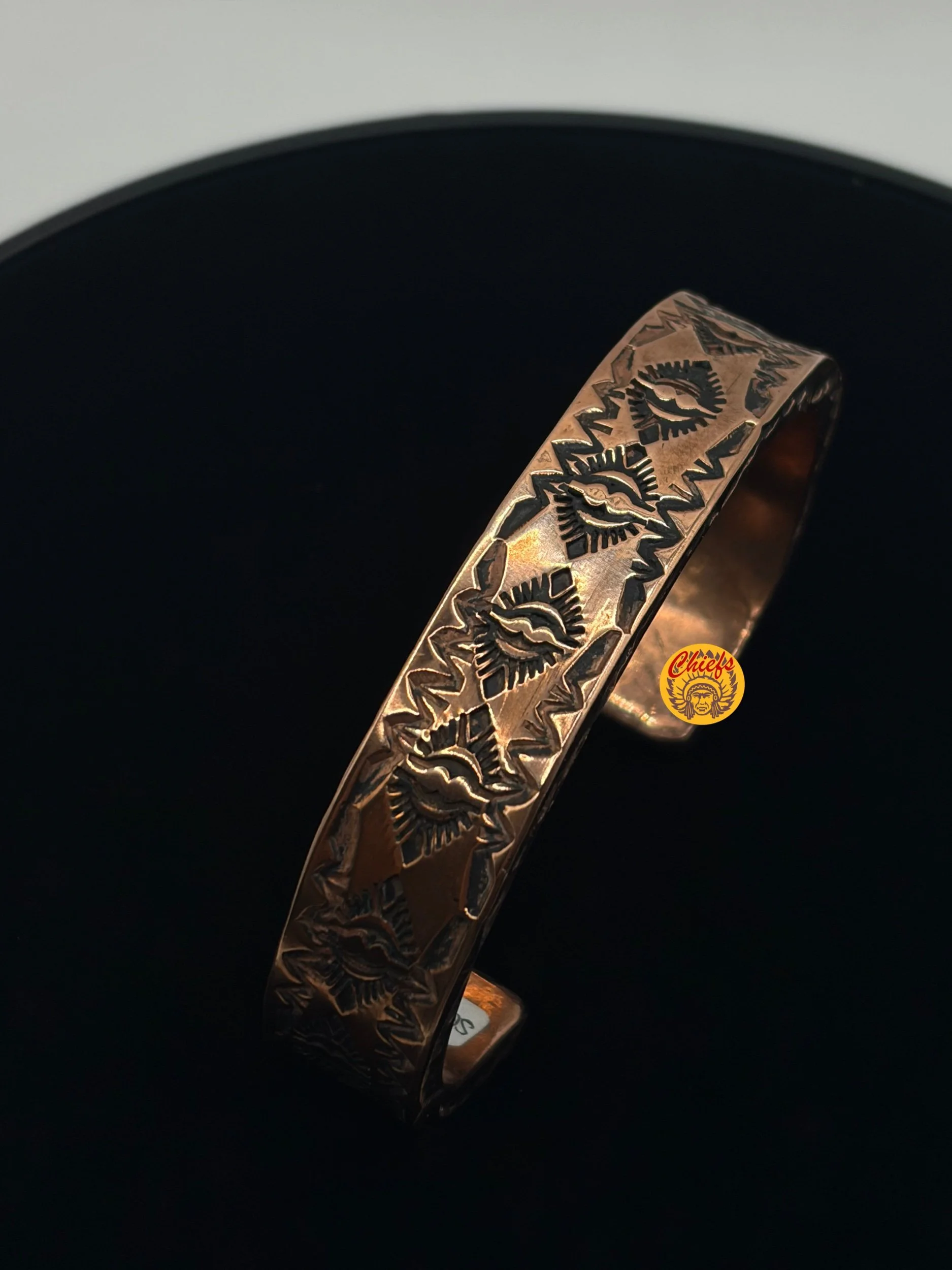 Canyon Sun Copper Cuff

This hand-stamped copper cuff features a repeating southwestern sunburst motif with bold geometric detailing. The warm copper finish highlights the depth of the stamping, giving the piece a strong, grounded western feel