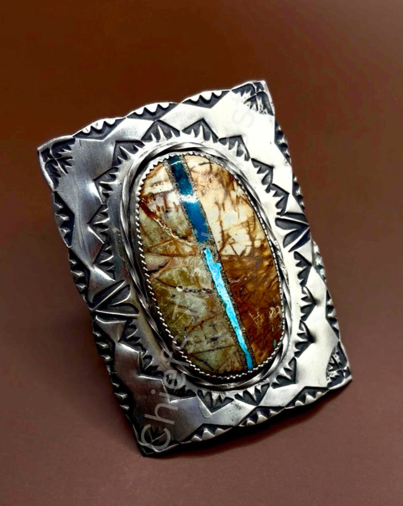 Royston Ribbon Adjustable Ring

Handcrafted by The Leather Chief, this striking statement ring features a genuine Royston Ribbon stone with a vivid turquoise vein running naturally through a rich earthy matrix. Set in sterling silver, the bold hand-s