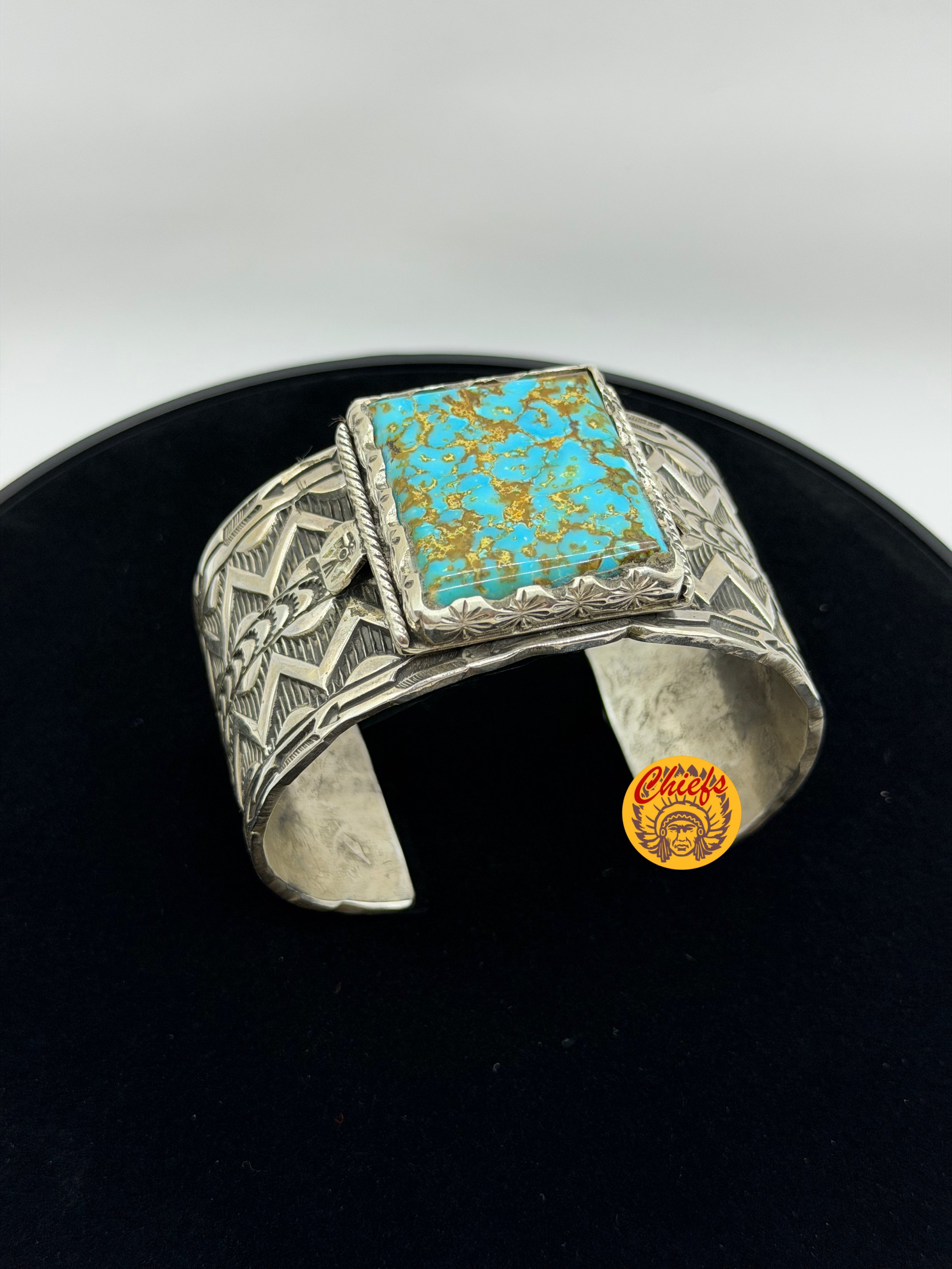 Kingman Turquoise Hand Stamped Sterling Cuff

This striking cuff features a genuine Kingman turquoise stone, set in a bold 10-gauge sterling silver hand stamped cuff. The square turquoise cabochon is framed by hand-stamped detailing and bordered with